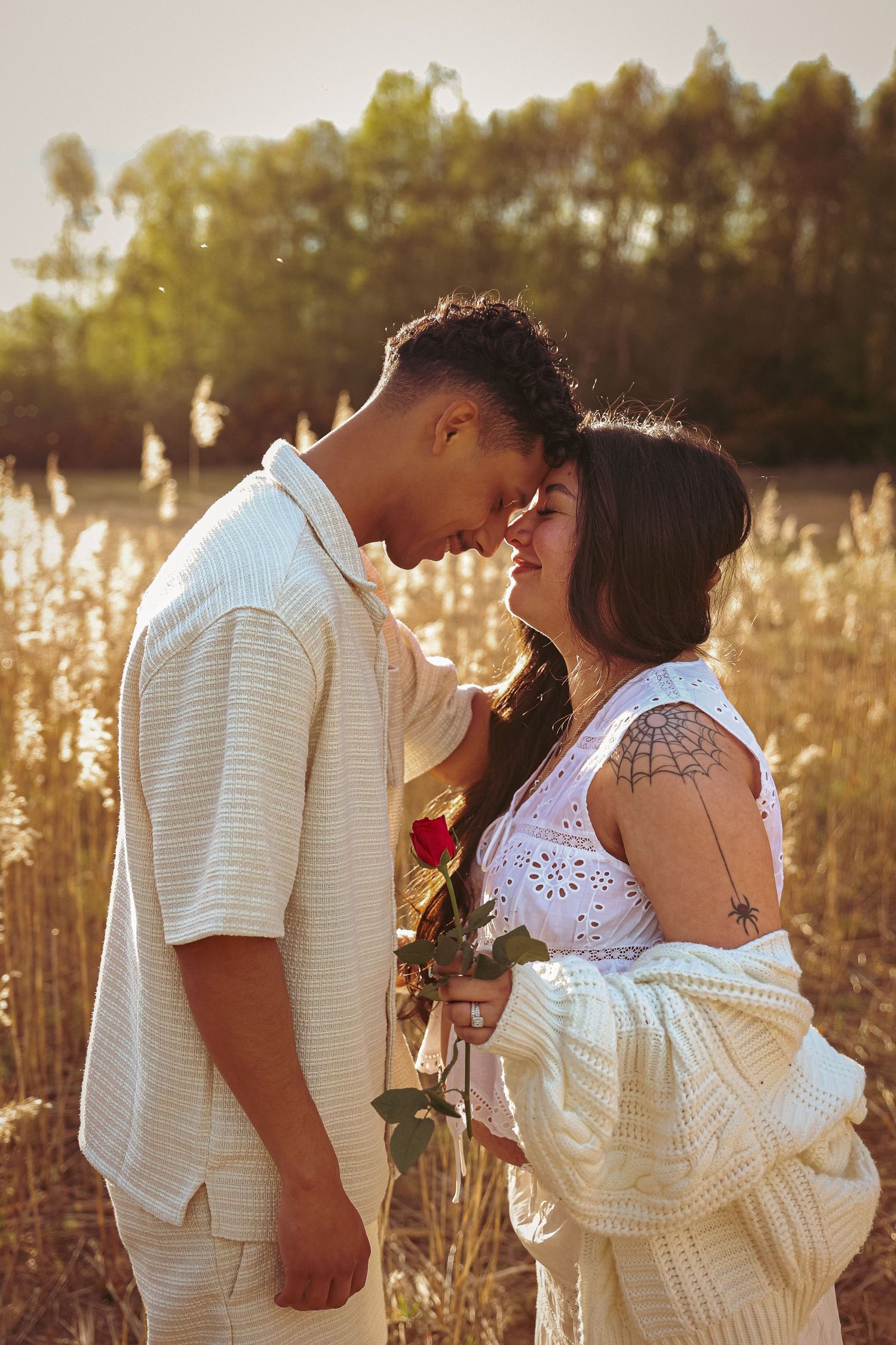 Romantic portrait of an expecting couple during golden house , foreheads together , laughing, basking in their shared love. Maternity photo