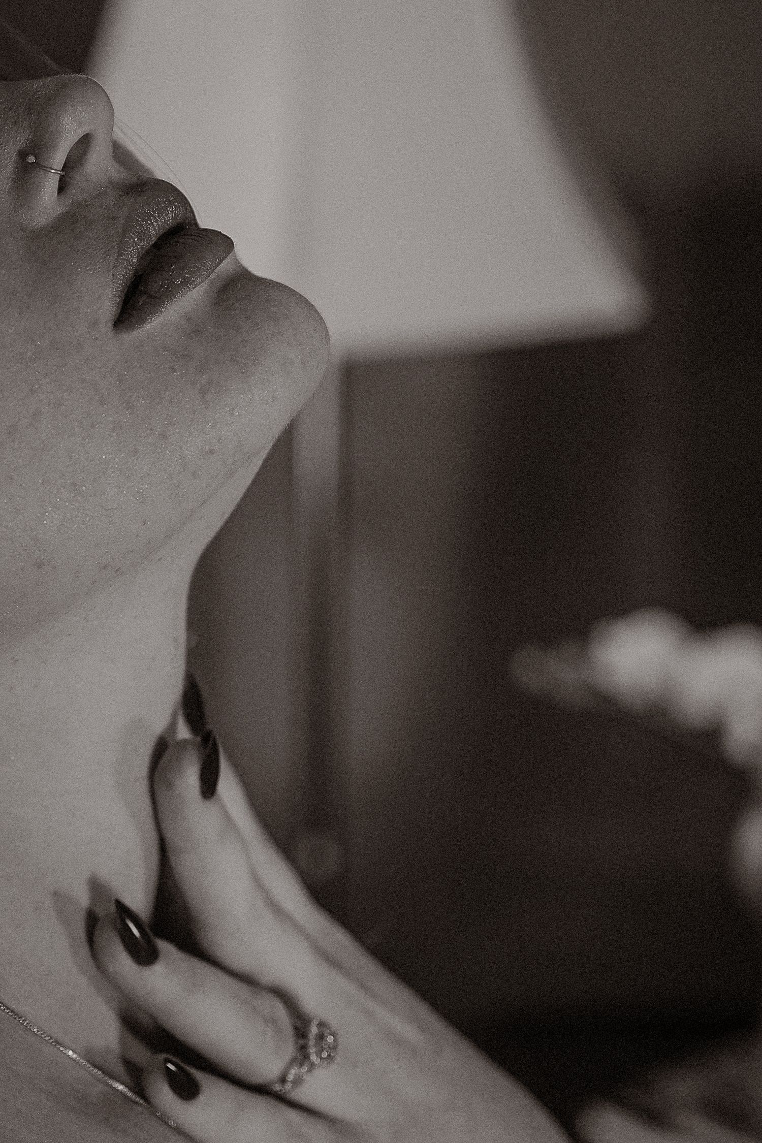 Female gaze self reclamation portrait photography for women, specialised in boudoir. Cropped detail of woman's profile and hand, monochrome