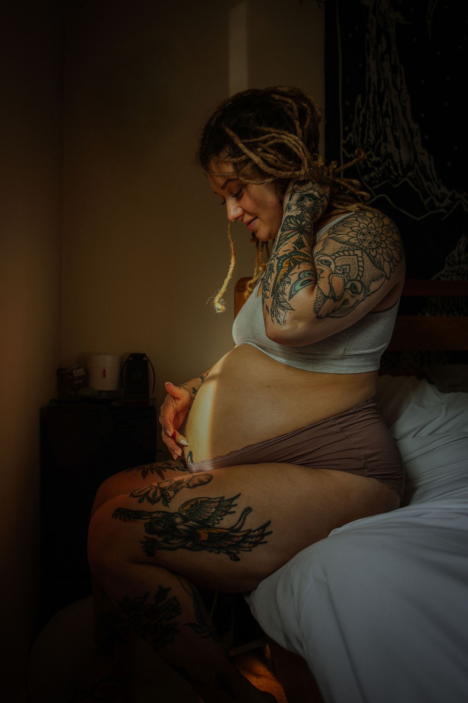 Close up emotive at home maternity photoshoot , beautiful tattooed mama, natural light on bump, captured in Ipswich by Untamed Muses