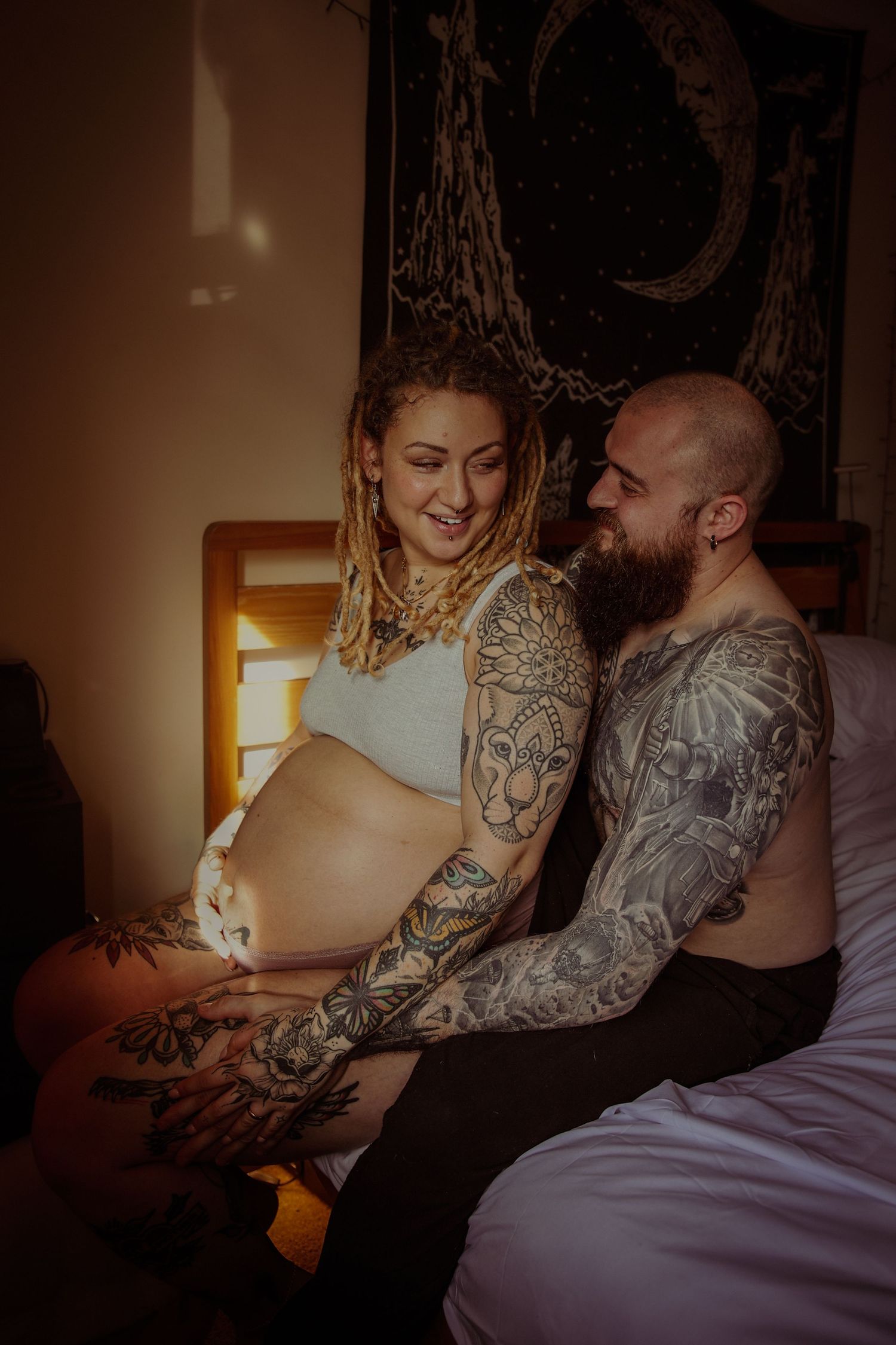 Emotive maternity couple portrait in the sanctuary of their home, warm light bathing the room. Capture pregnancy with Untamed Muses, Norfolk