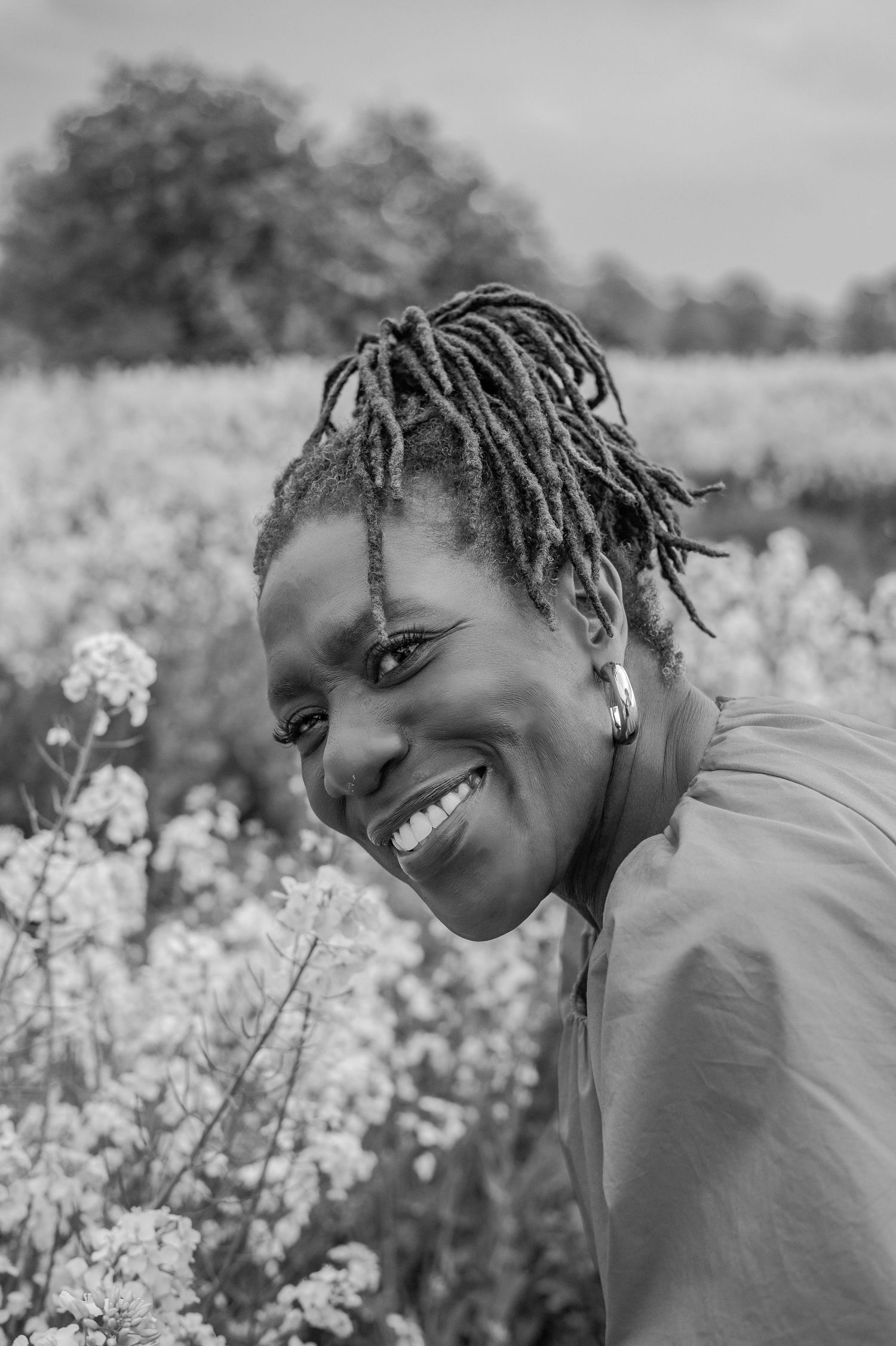 Personal Branding candid portrait for Franstine Jones, in Norfolk in a field in bloom, monochrome , beautiful by Untamed Muses empowerment