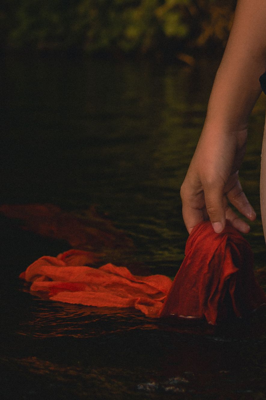 sensory detail of hand drawing a scarf in the river water, slow, sensual, feminine. Boudoir photography empowerment in Norfolk