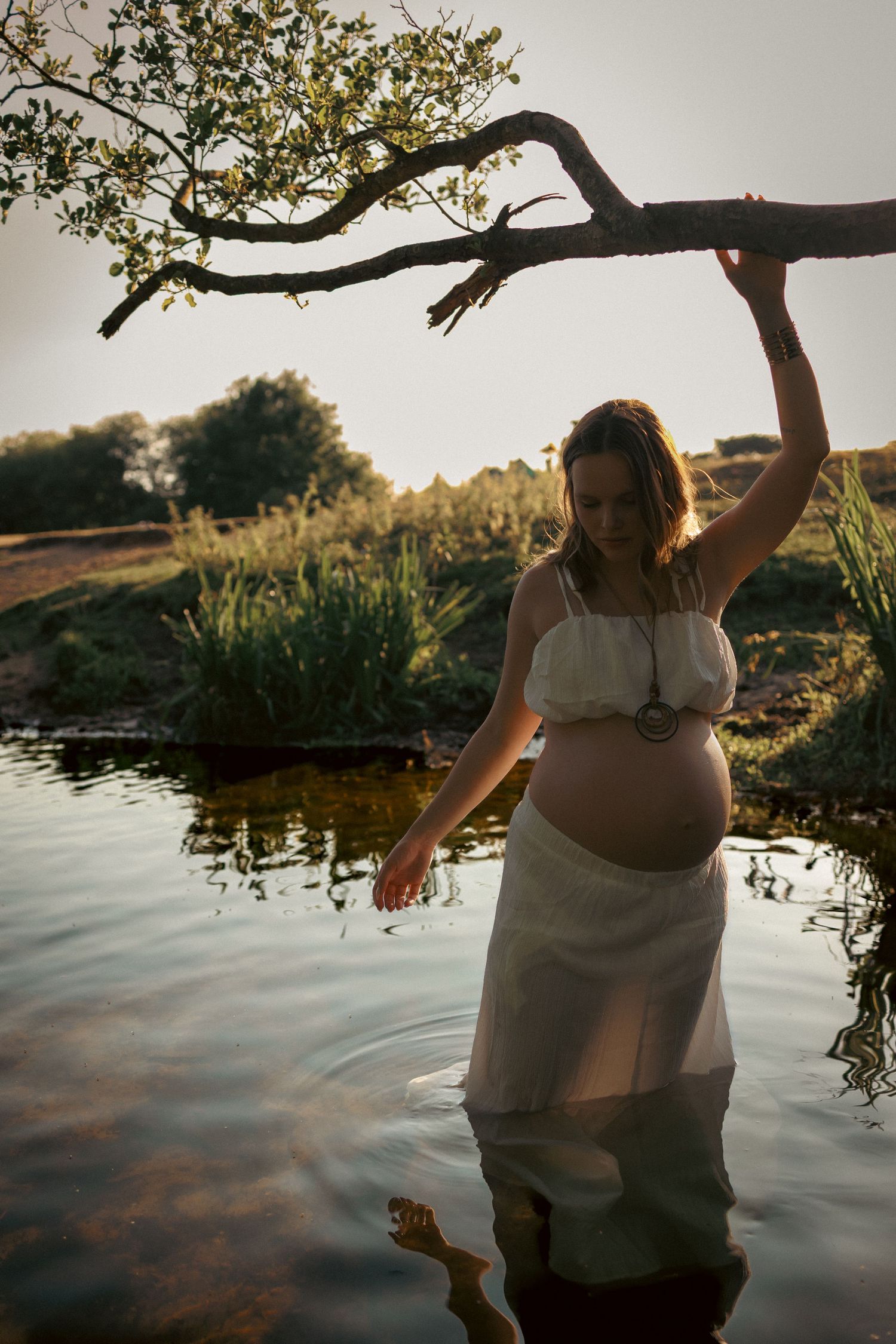 Beautiful portrait from a maternity session in a norfolk river, golden light goddess captured by the female gaze of untamed muses