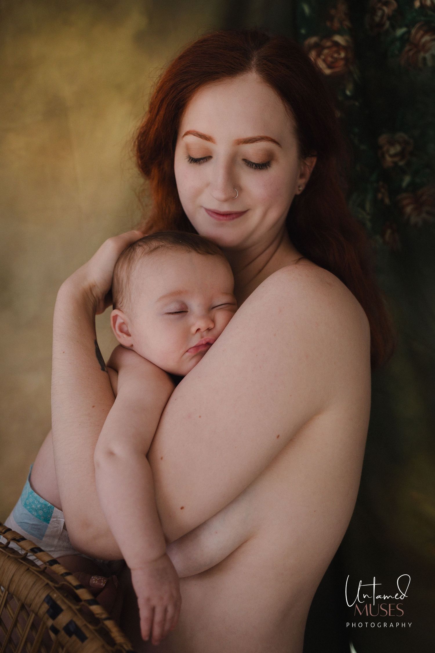Intimate motherhood portrait in studio of mother holding sleeping baby in arms, painterly vibes, captures by Untamed muses in Thetford