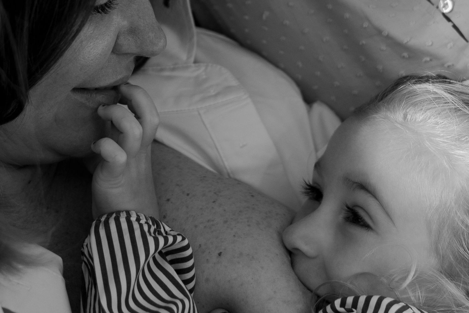 monochrome close up of a moment of quiet connection in motherhood, love in visual form. Motherhood photography in Suffolk