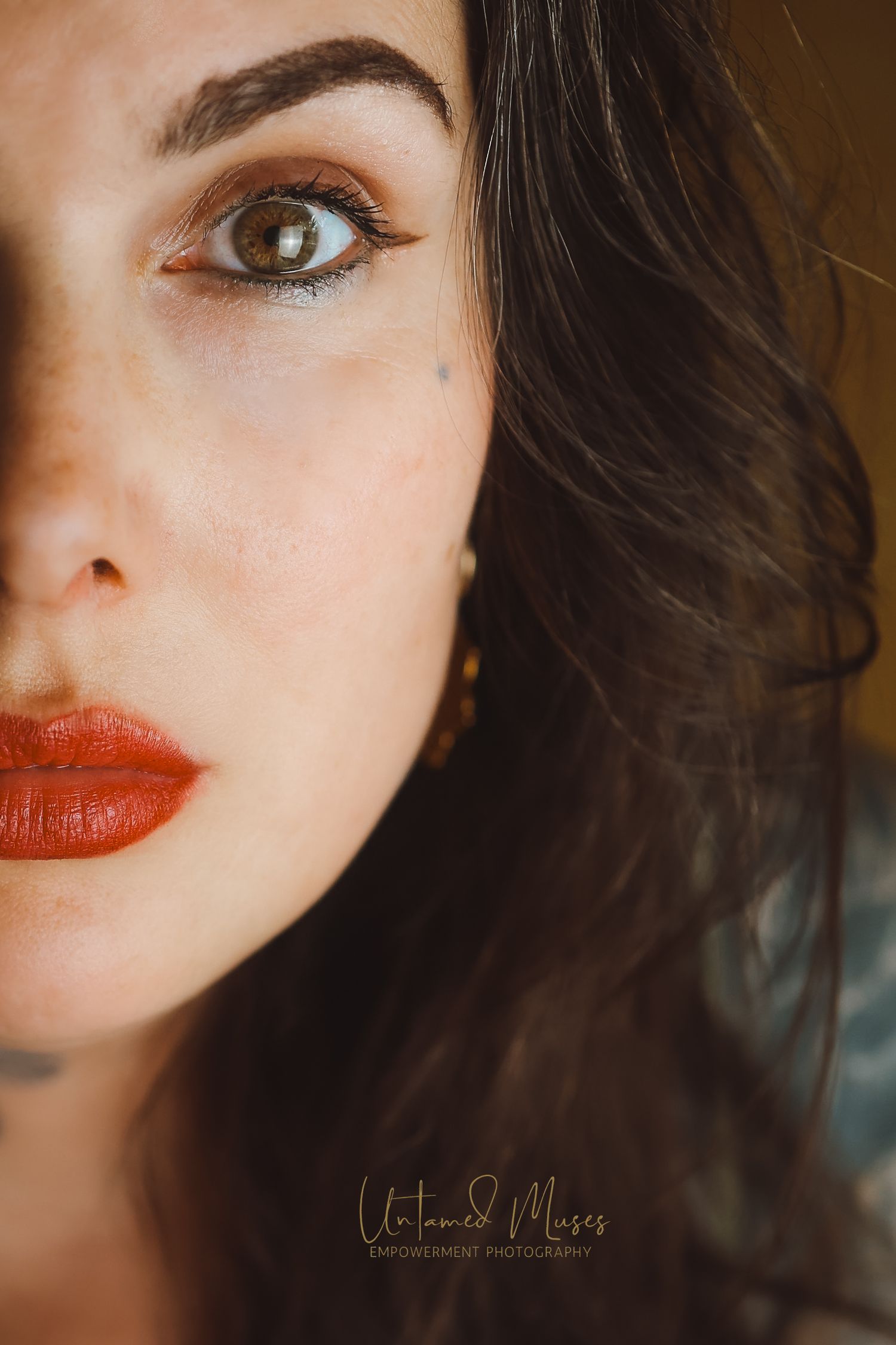 Portrait of close up of half of Samantha Cortes's face, wearing red lip and staring boldly to the camera, Empowerment Boudoir Thetford