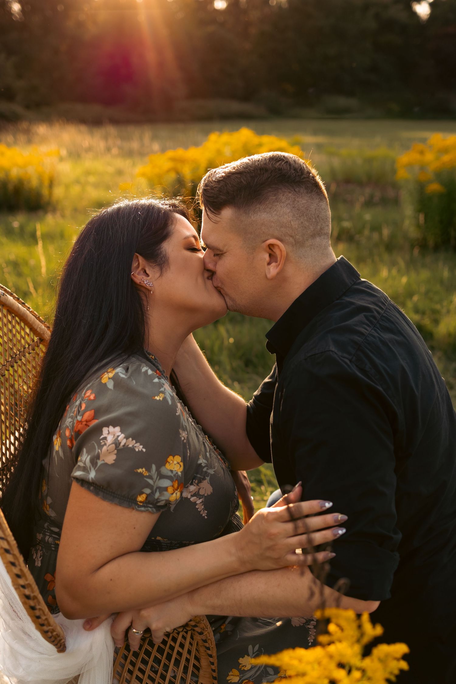 portrait of expecting couple kissing at golden hour in a Norfolk field, tender emotive moment captures by Untamed Muses in Thetford