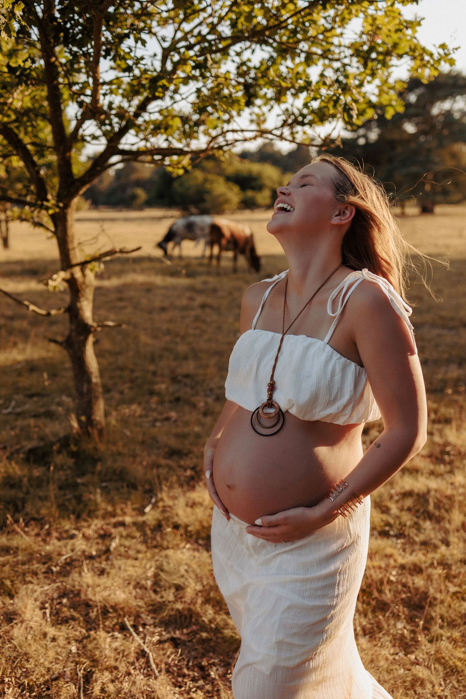 Outdoors cinematic maternity photography in Norfolk, untamed muses capturing the power of woman