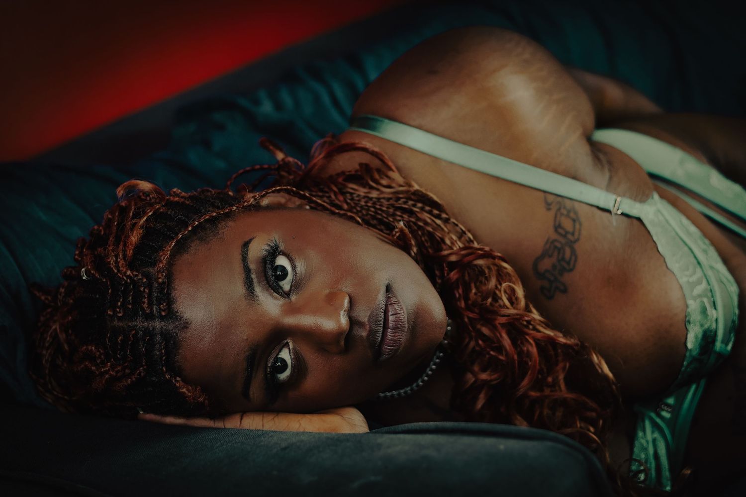 Boudoir empowerment photoshoot at Ipswich home, featuring stunning black woman in green underwear by Untamed Muses