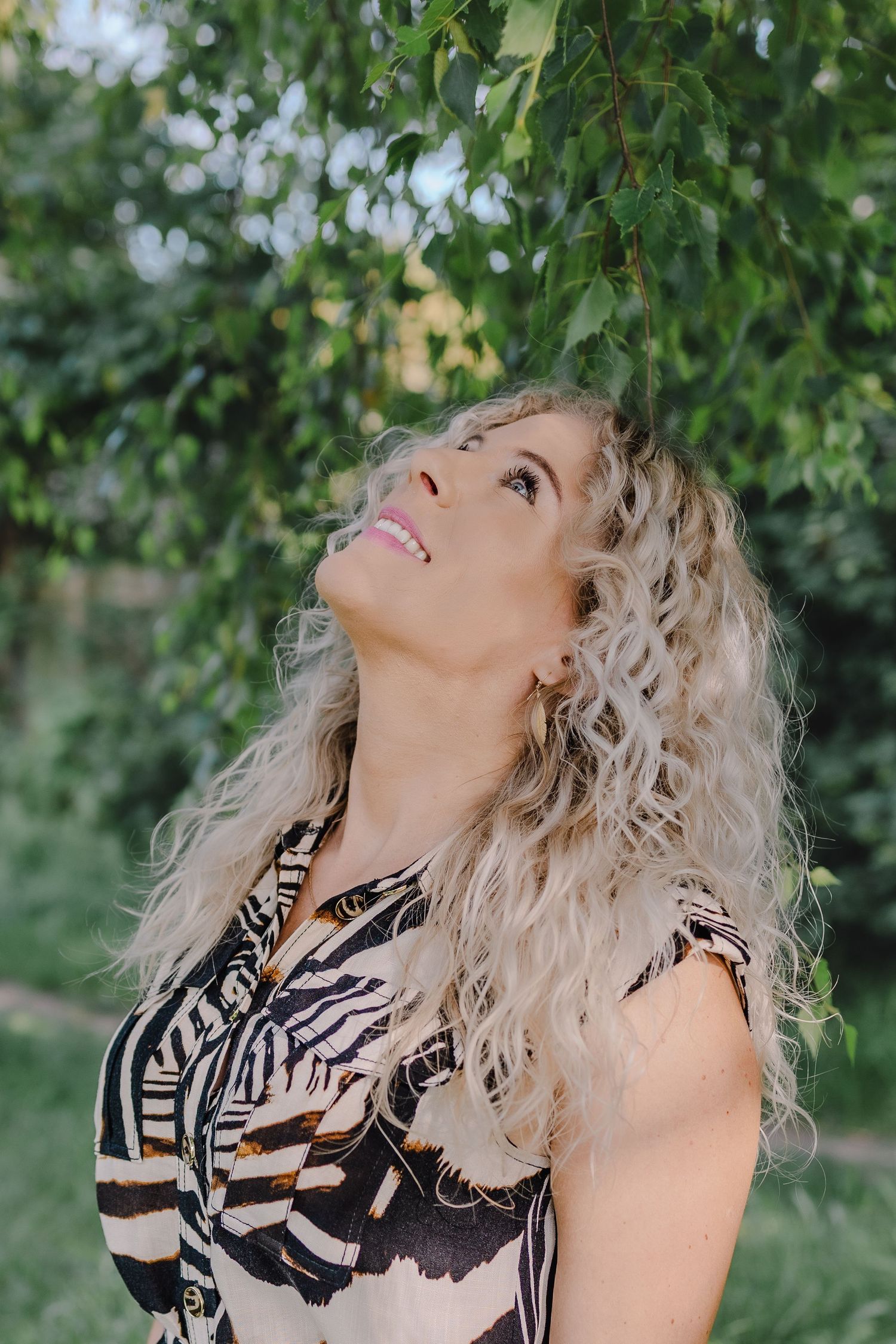 Portrait of women looking up into the trees, smiling, relaxed in nature, personal branding photography session by untamed muses in suffolk