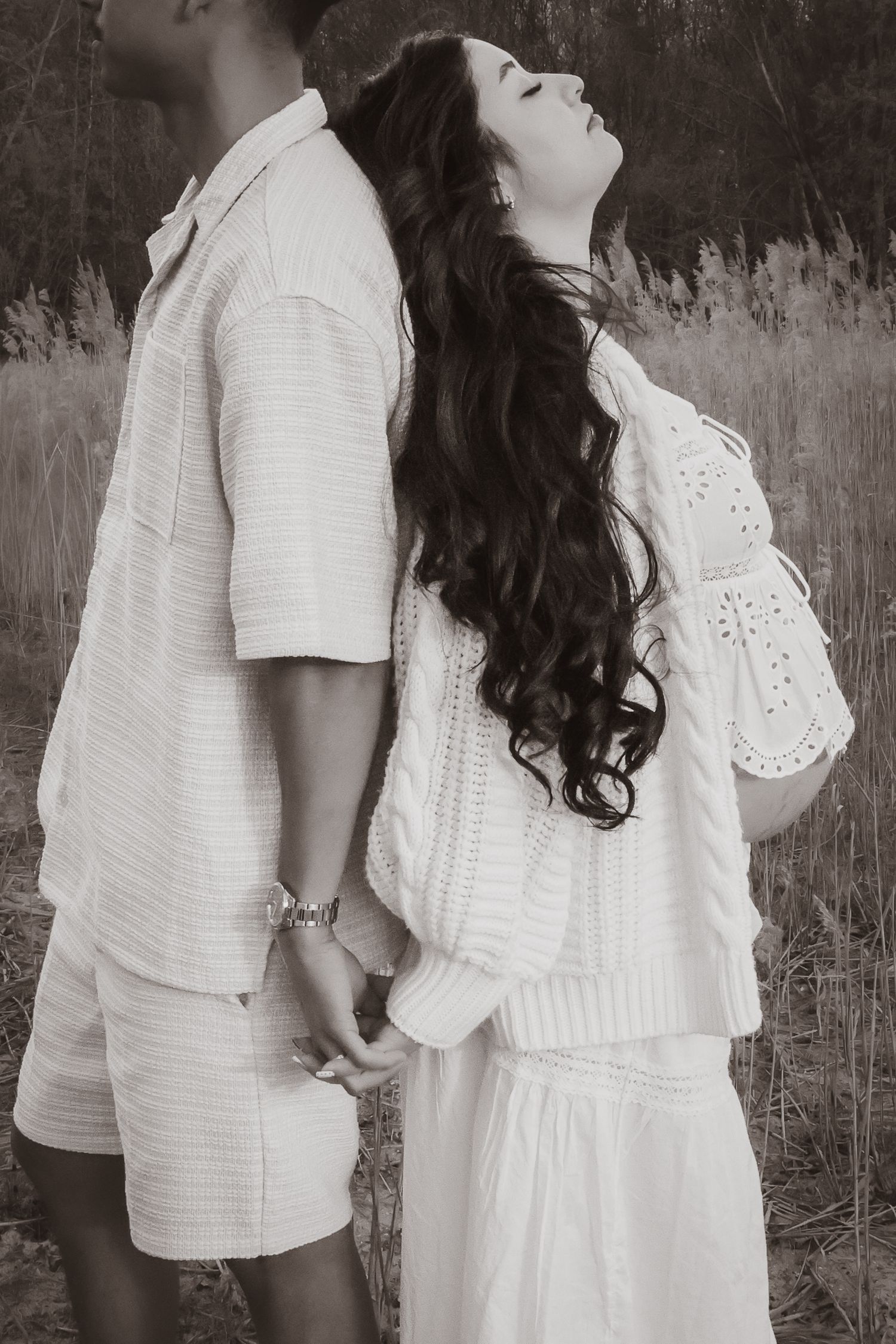 monochrome emotive moment at sunset between expecting couple in Norfolk during their maternity photoshoot with untamed muses photographer