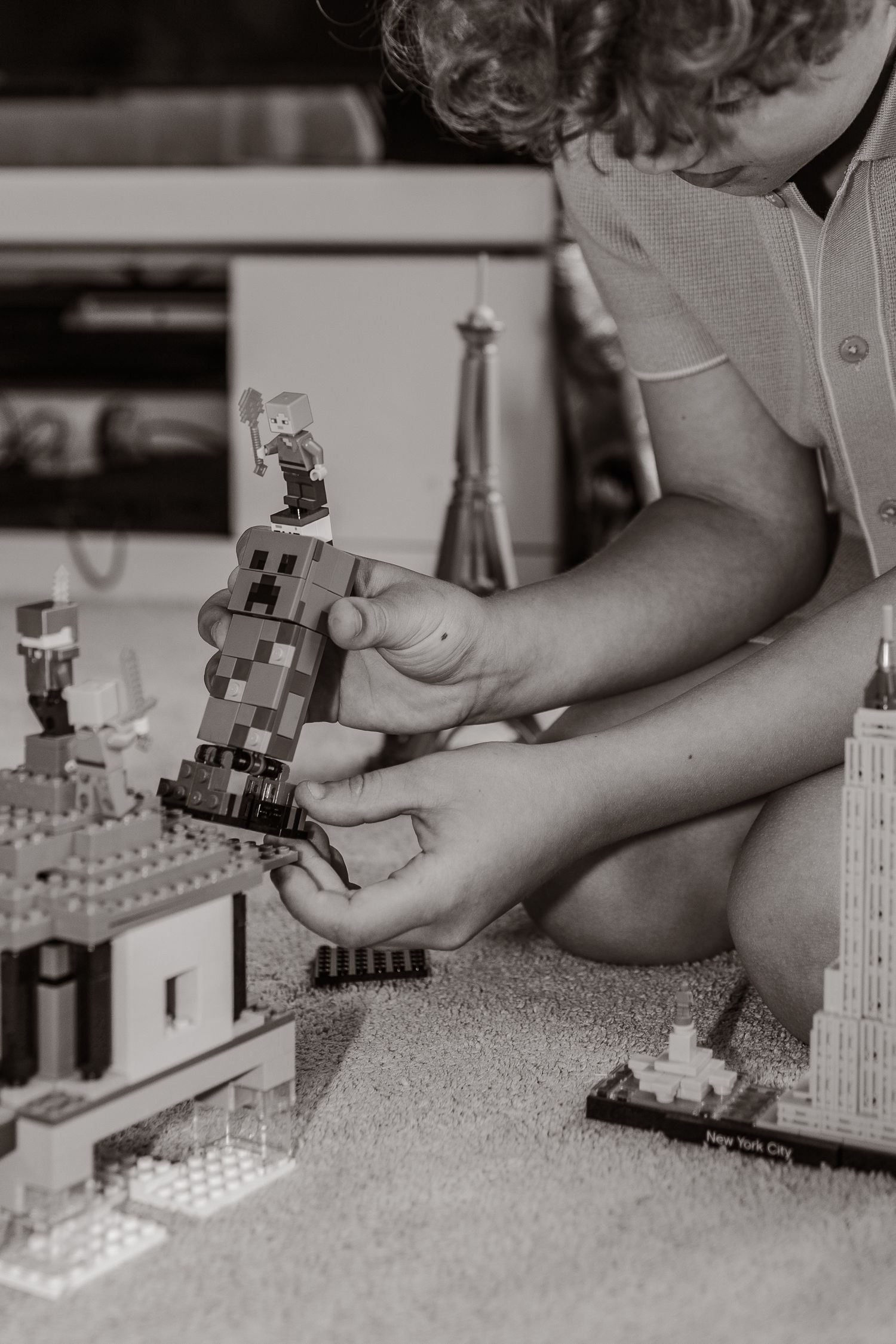 monochrome close up of child hands playing with  lego and Minecraft characters