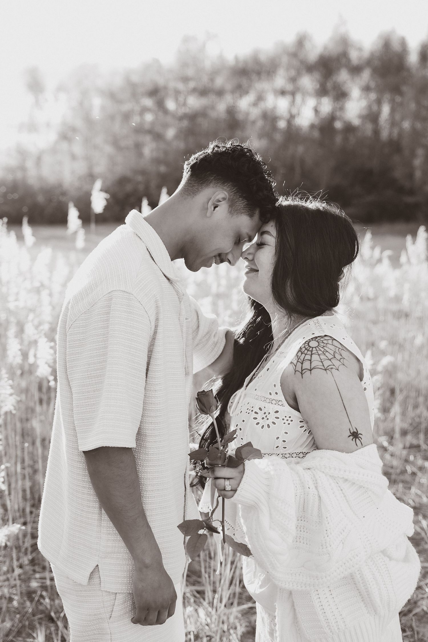 monochrome emotive moment at sunset between expecting couple in Norfolk during their maternity photoshoot with untamed muses photographer