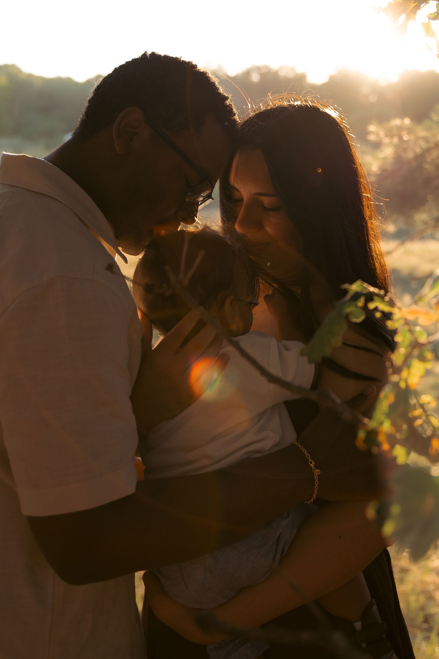 Interracial RAF family portrait, emotive, cinematic, golden hour, sharing a tender moment of connection , documented by Untamed Muses