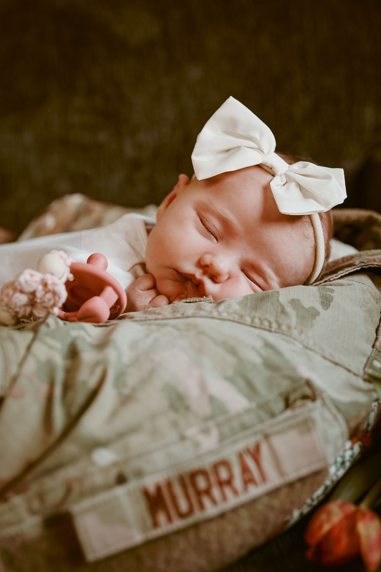 Military Newborn at home photoshoot portrait of newborn baby girl in her RAF dads shirt and name tag, Timeless, bespoke, Untamed Muses