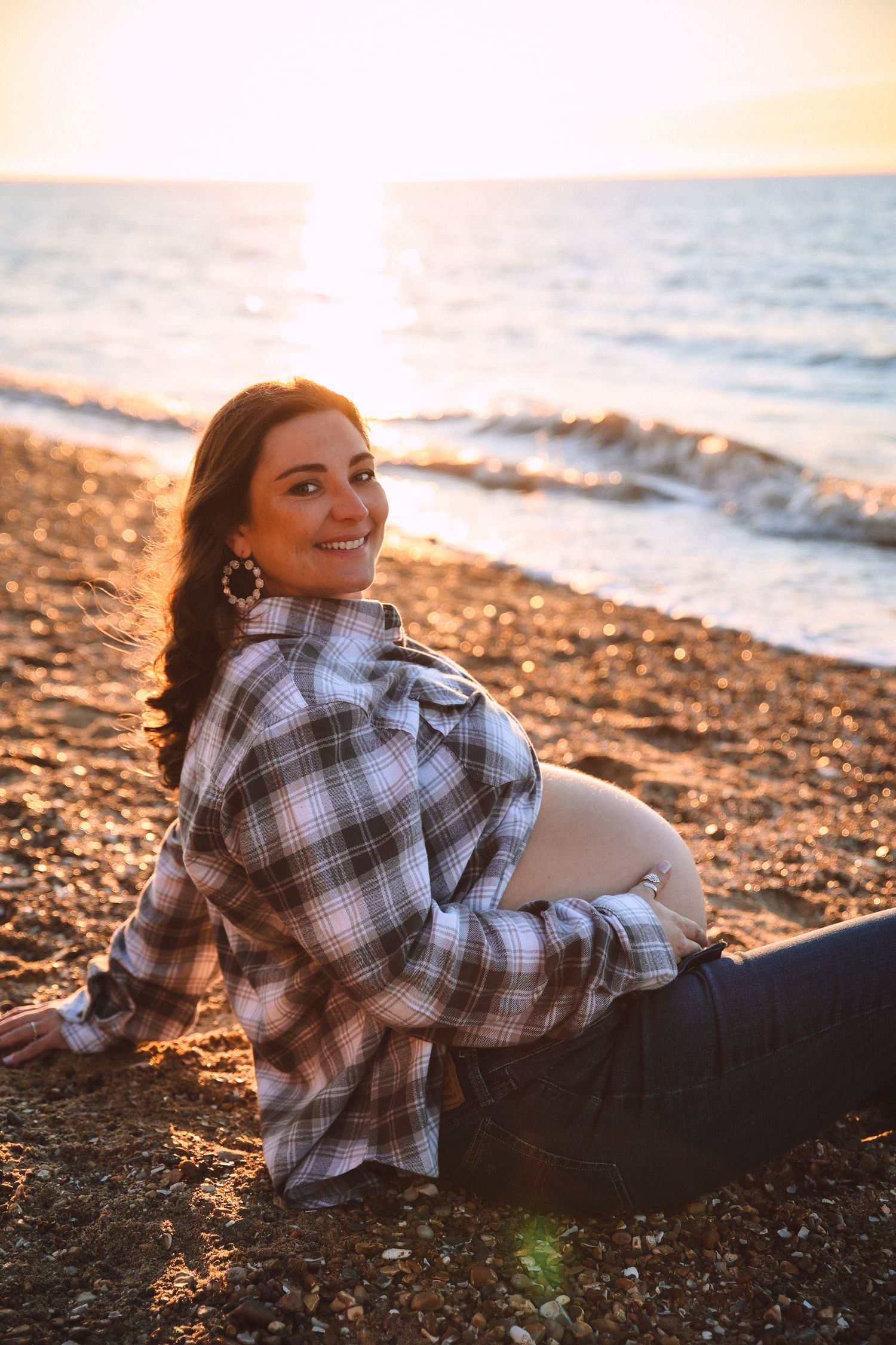 Maternity photography in Norfolk, captured outdoors maternity photography in golden light, golden light, sea, smiling by untamed muses