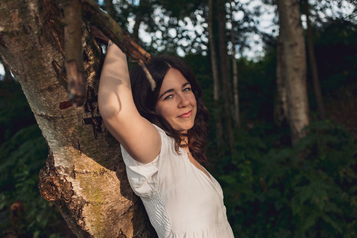 Empowerment Muse portrait of woman smiling against a tree ,Norfolk lake by female gaze empowerment photography Untamed Muses