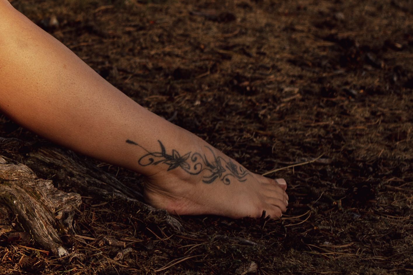 beautiful lady bare foot with a swirly floral tattoo, on earth, grounding, connecting with the elements, thetford