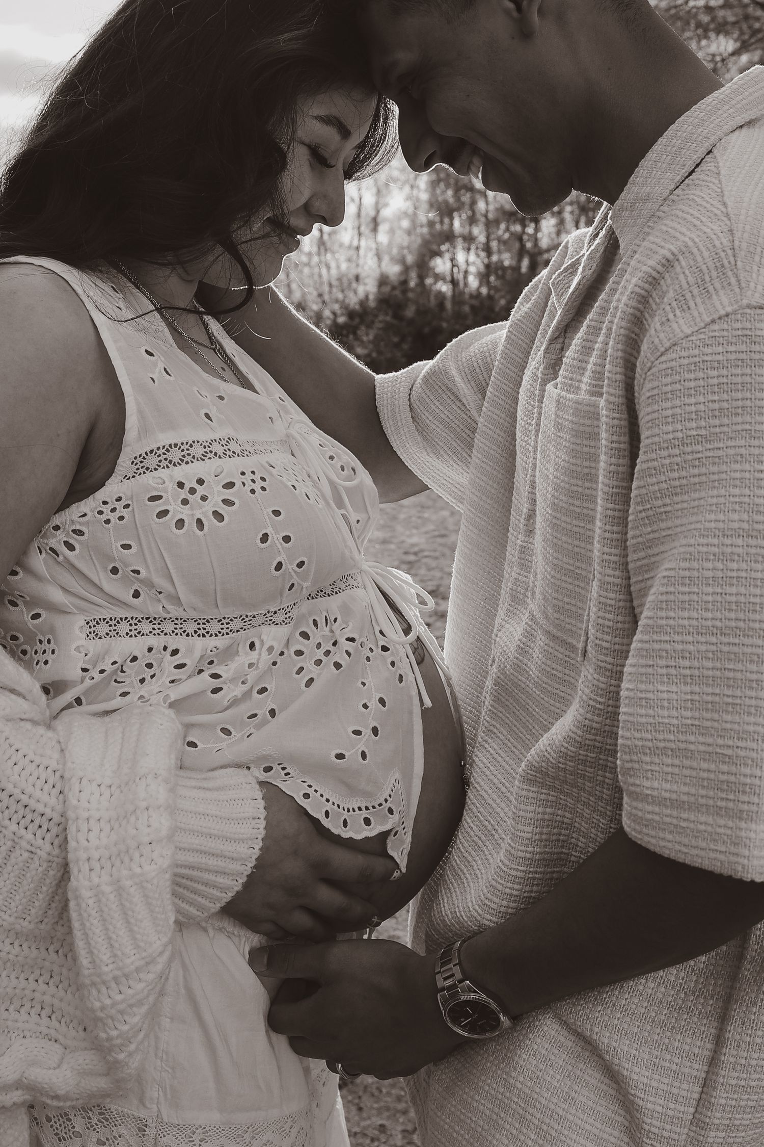 monochrome emotive moment at sunset between expecting couple in Norfolk during their maternity photoshoot with untamed muses photographer