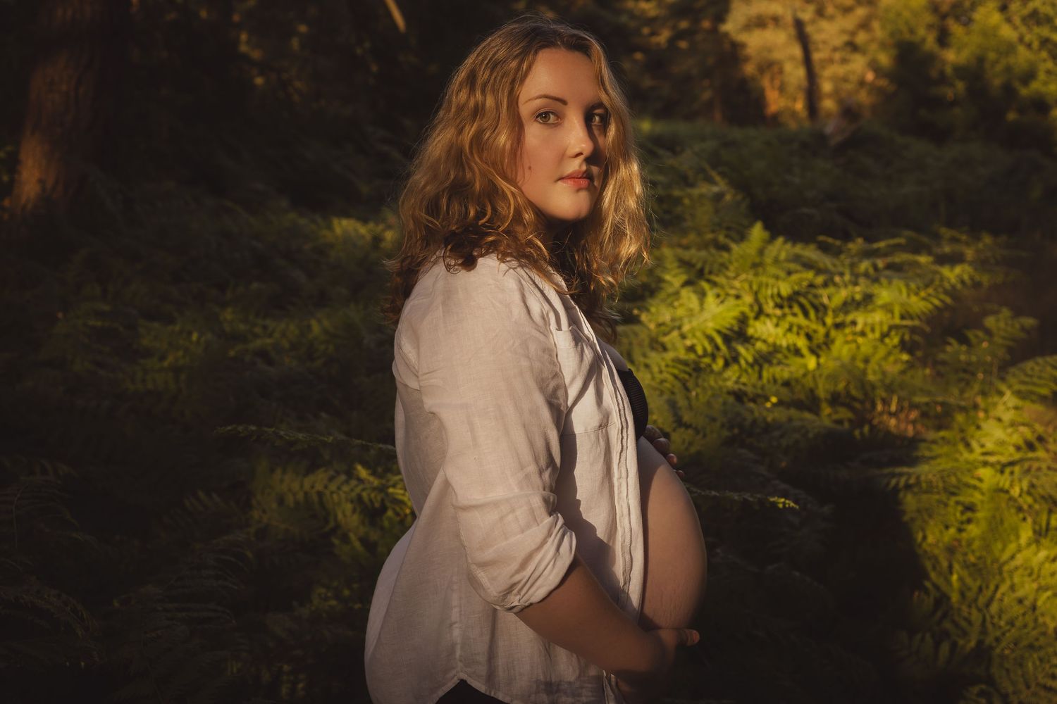 Empowerment Sun drenched portrait of pregnant beautiful woman surrounded by ferns in a Norfolk  woods by boudoir specialist Untamed Muses