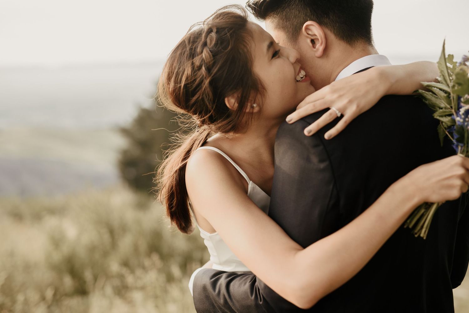 Couple embracing on Port Hills for their wedding photos