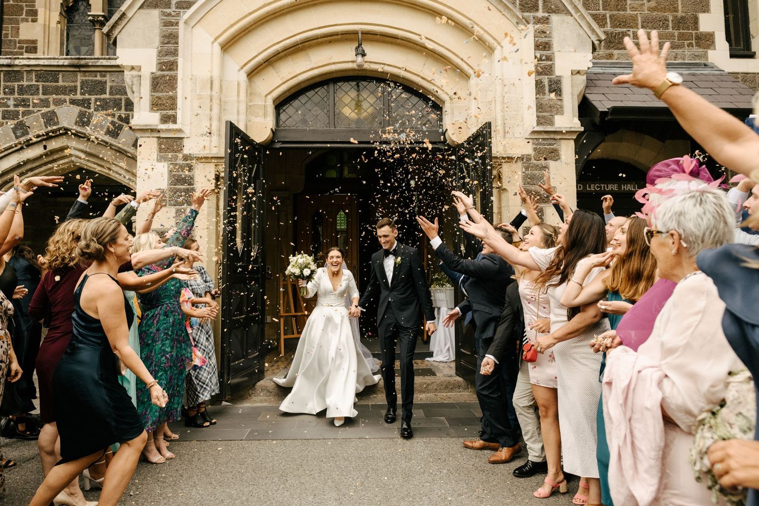 Bridal exit outside the Great Hall at the Arts Centre in Christchurch after the couple are married.