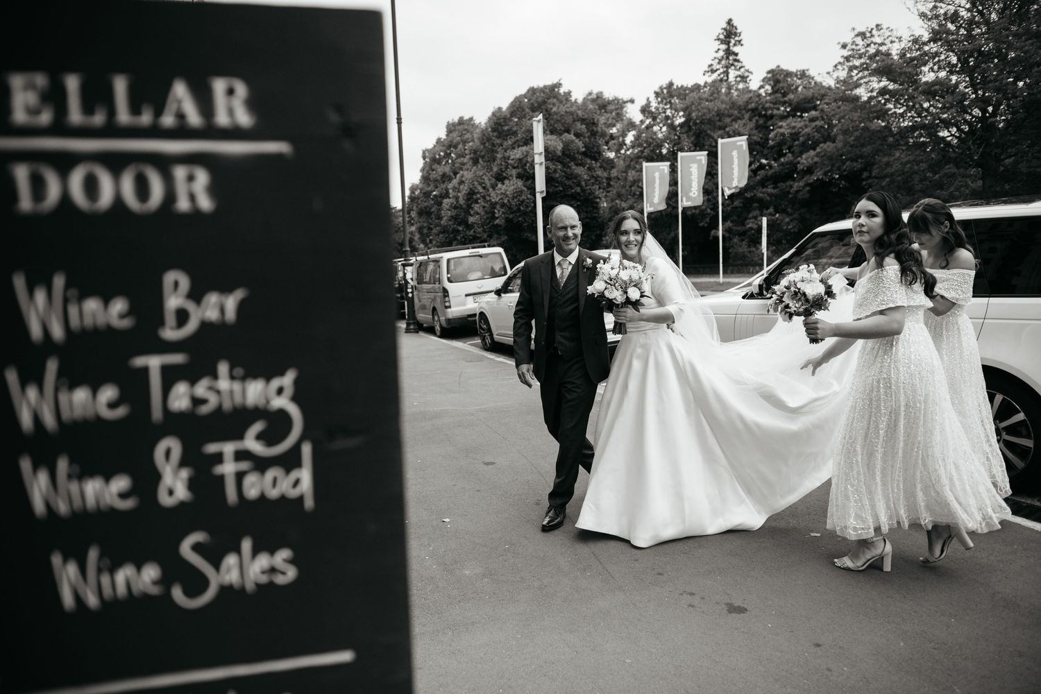 Cellar Door sign in front of bridal party as they arrive for a wedding at the Great Hall.