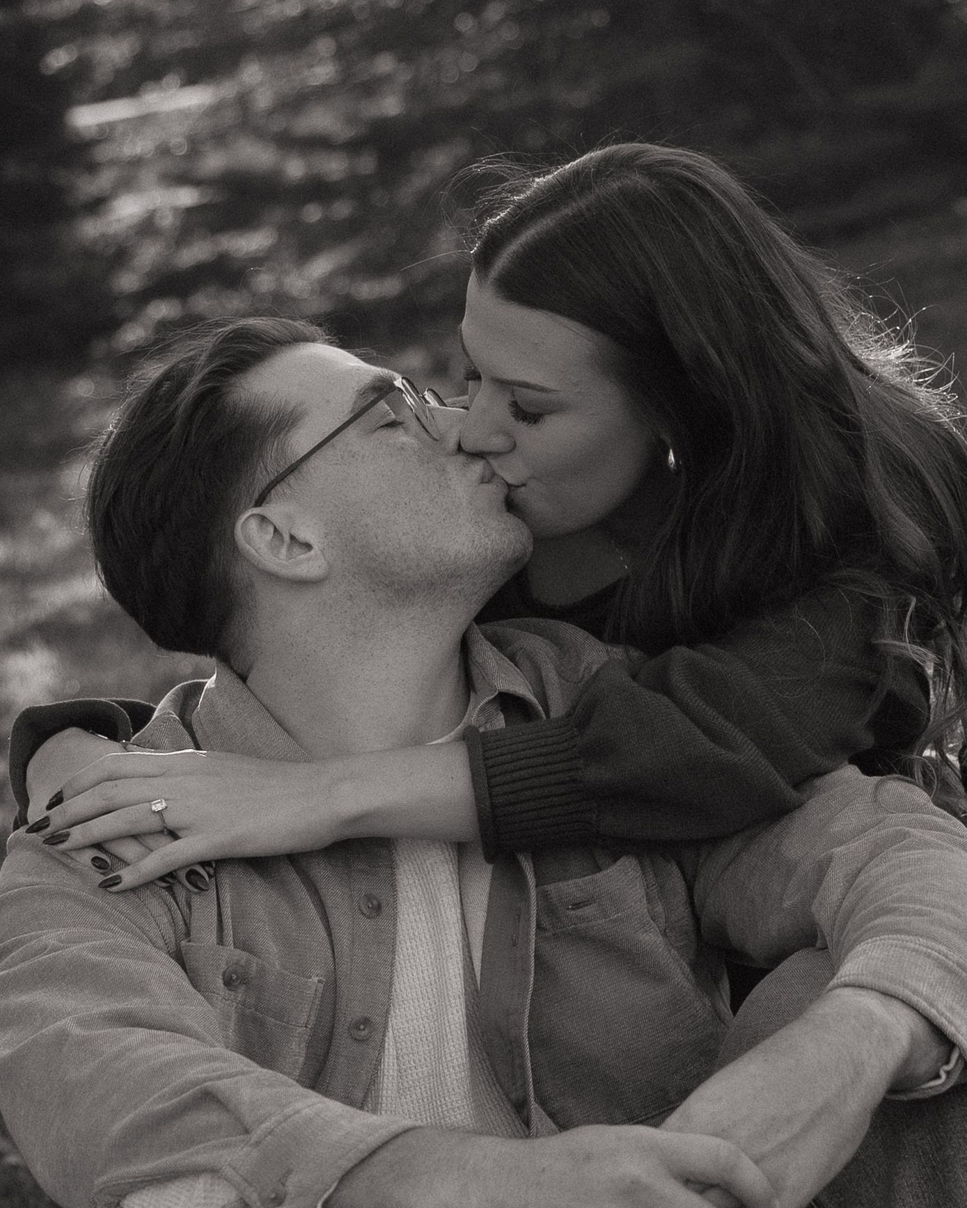 Couple seated together during relaxed engagement photos