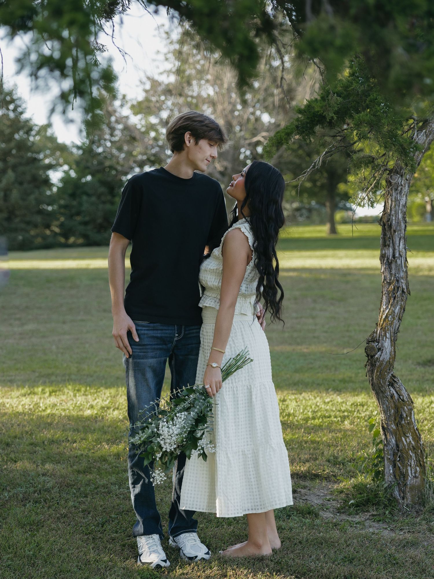 couple stands closely in colorful dramatic lighting