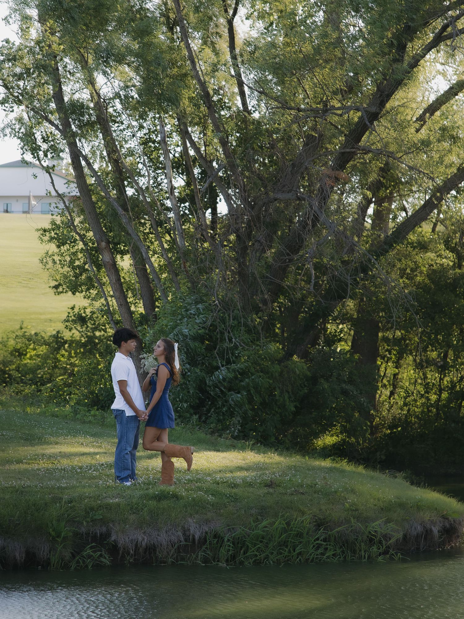 Couple portrait by water at sunset