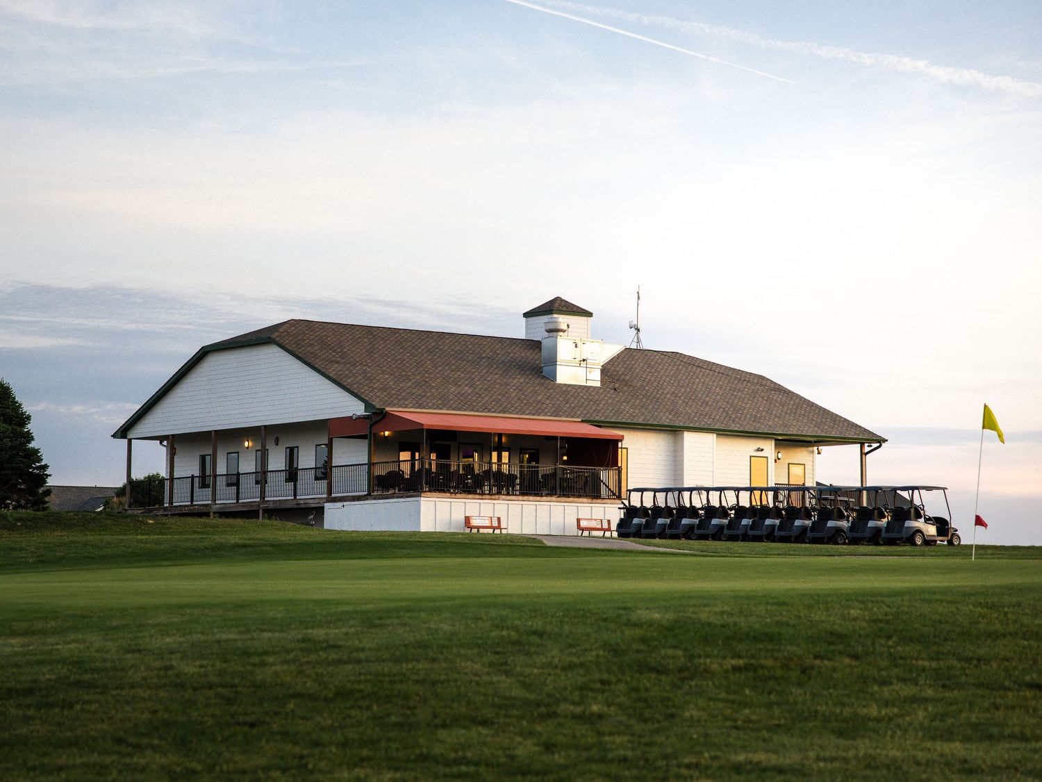 landscape of golf course club house and restaurant real estate photo at golden hour