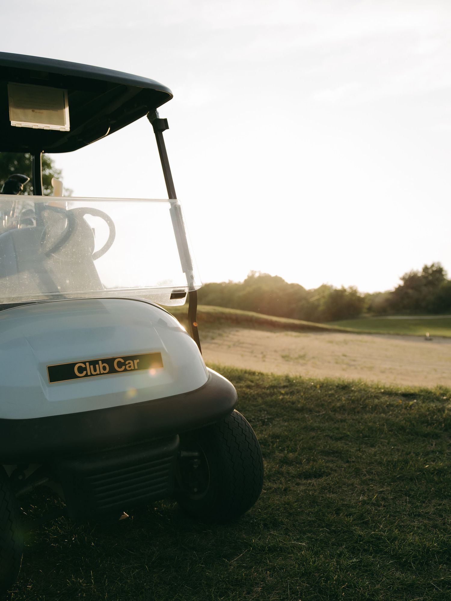 dramatic bright lens flare with golf cart and candid movement