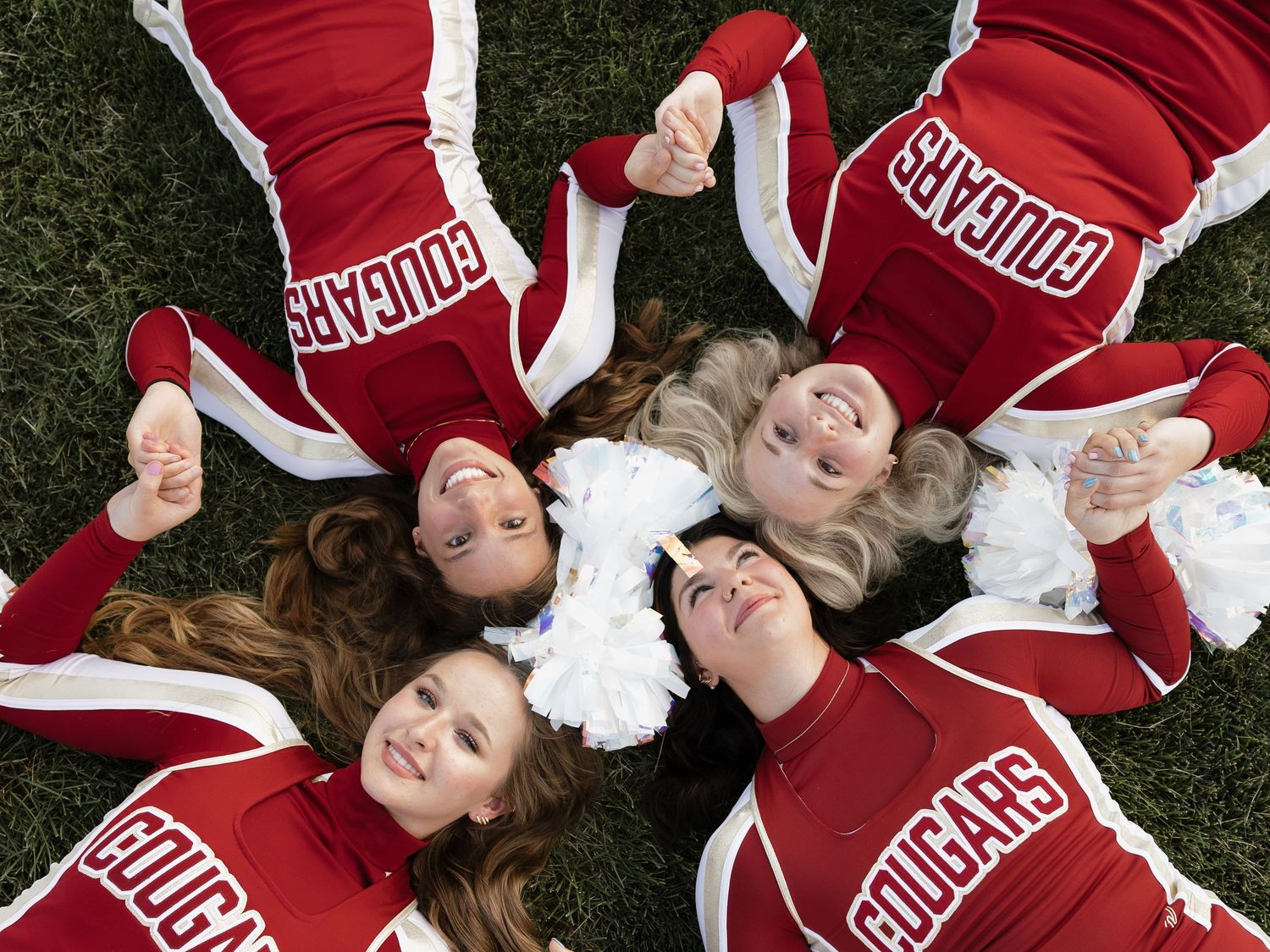 group of cheerleaders laughing and smiling candidly
