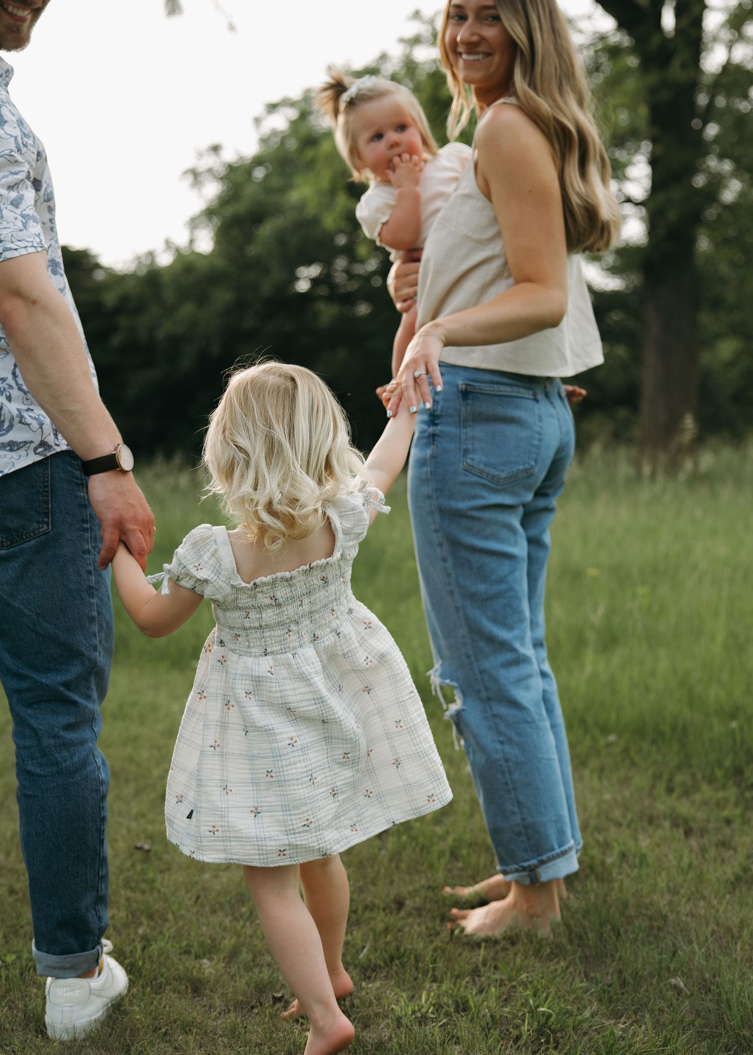 candid emotional family holding hands outdoors
