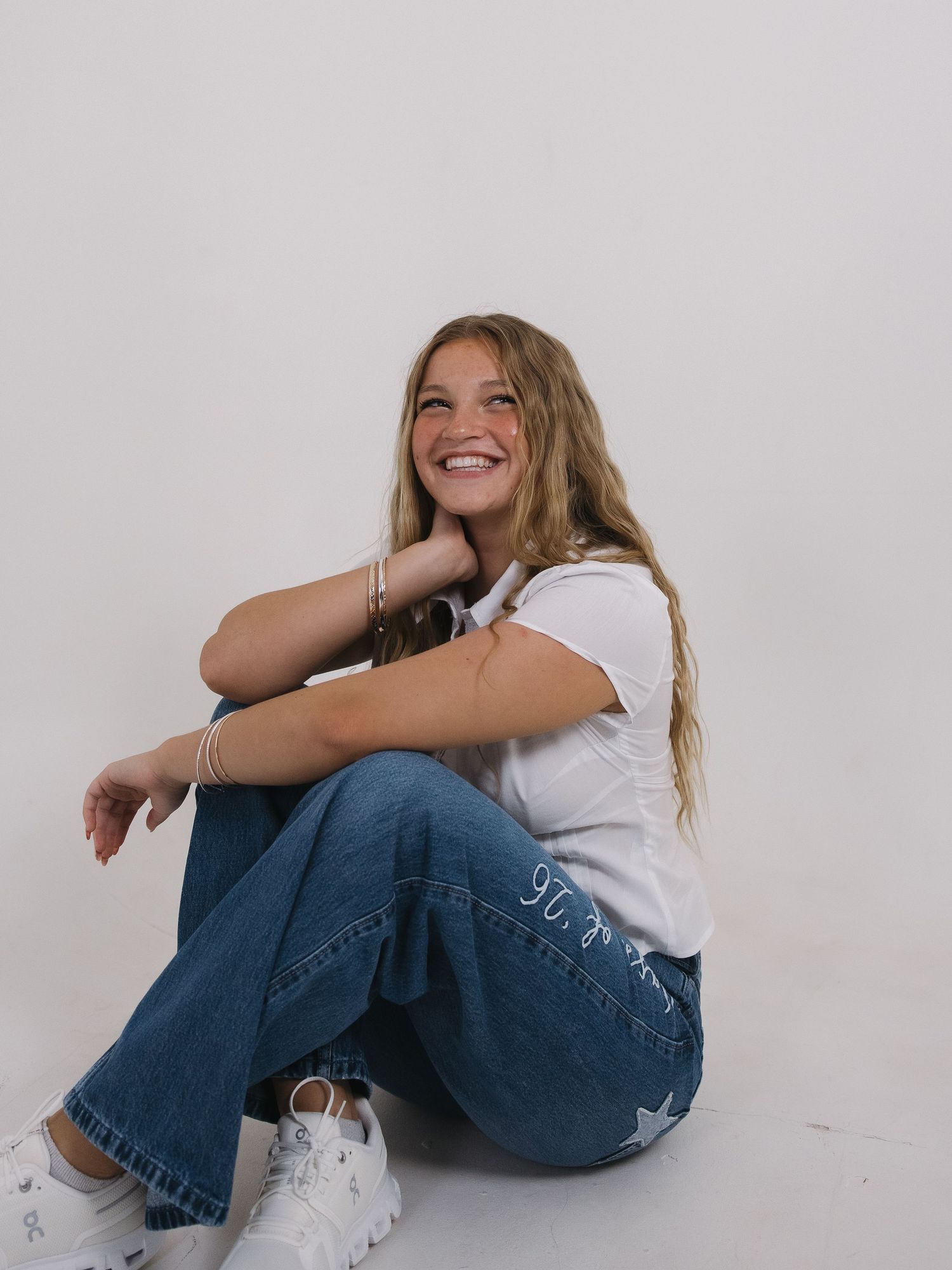 Graduate seated during relaxed senior portrait