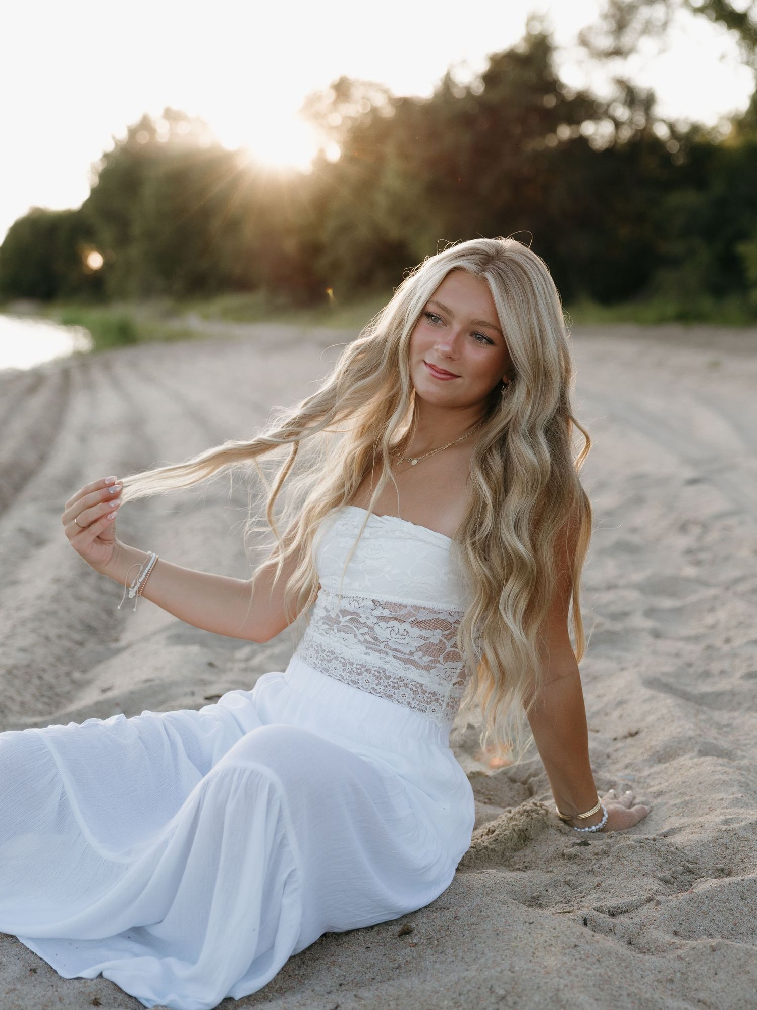 water graduation portrait with lake background
