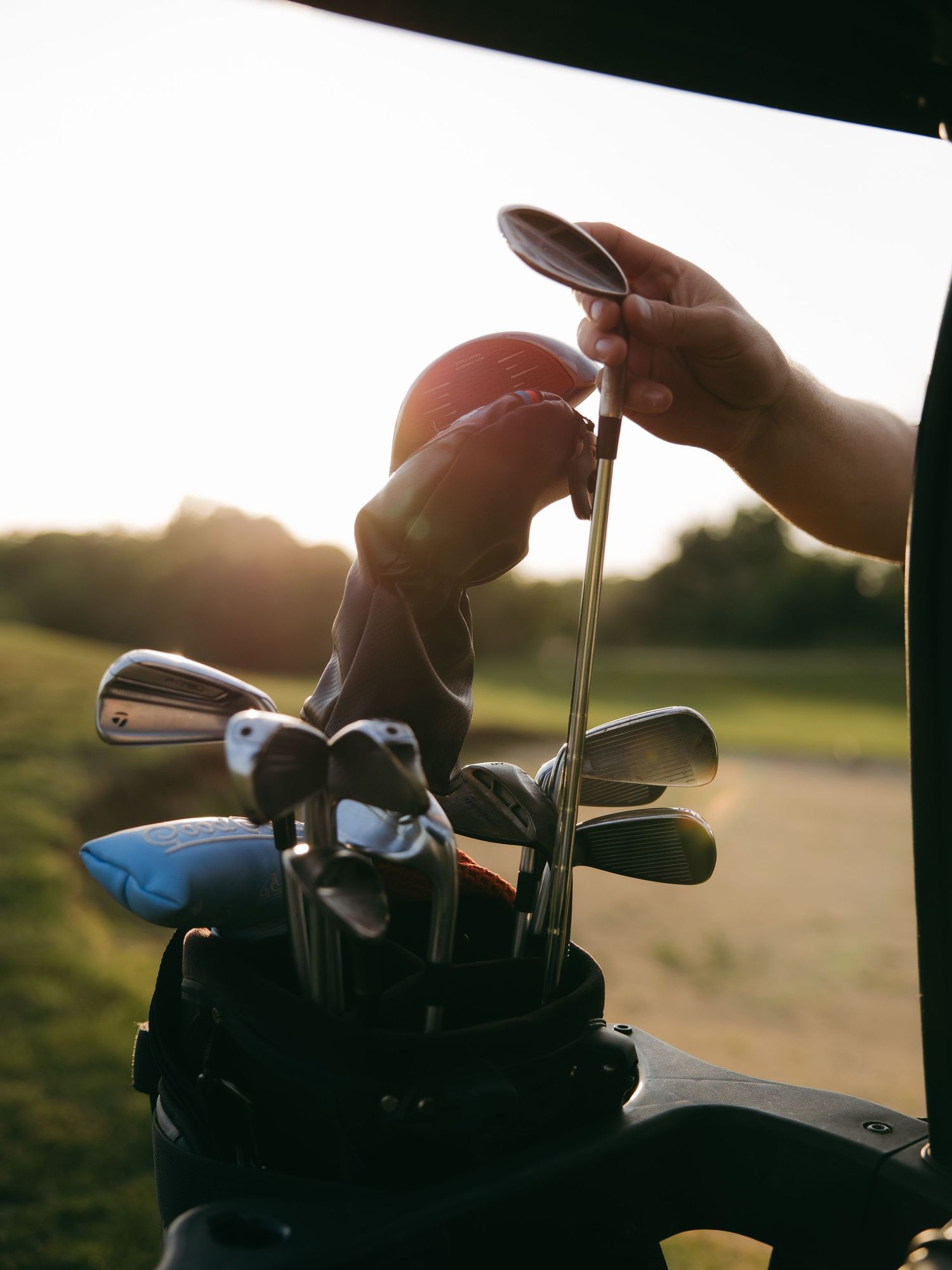 dramatic bright lens flare with golf clubs and candid movement