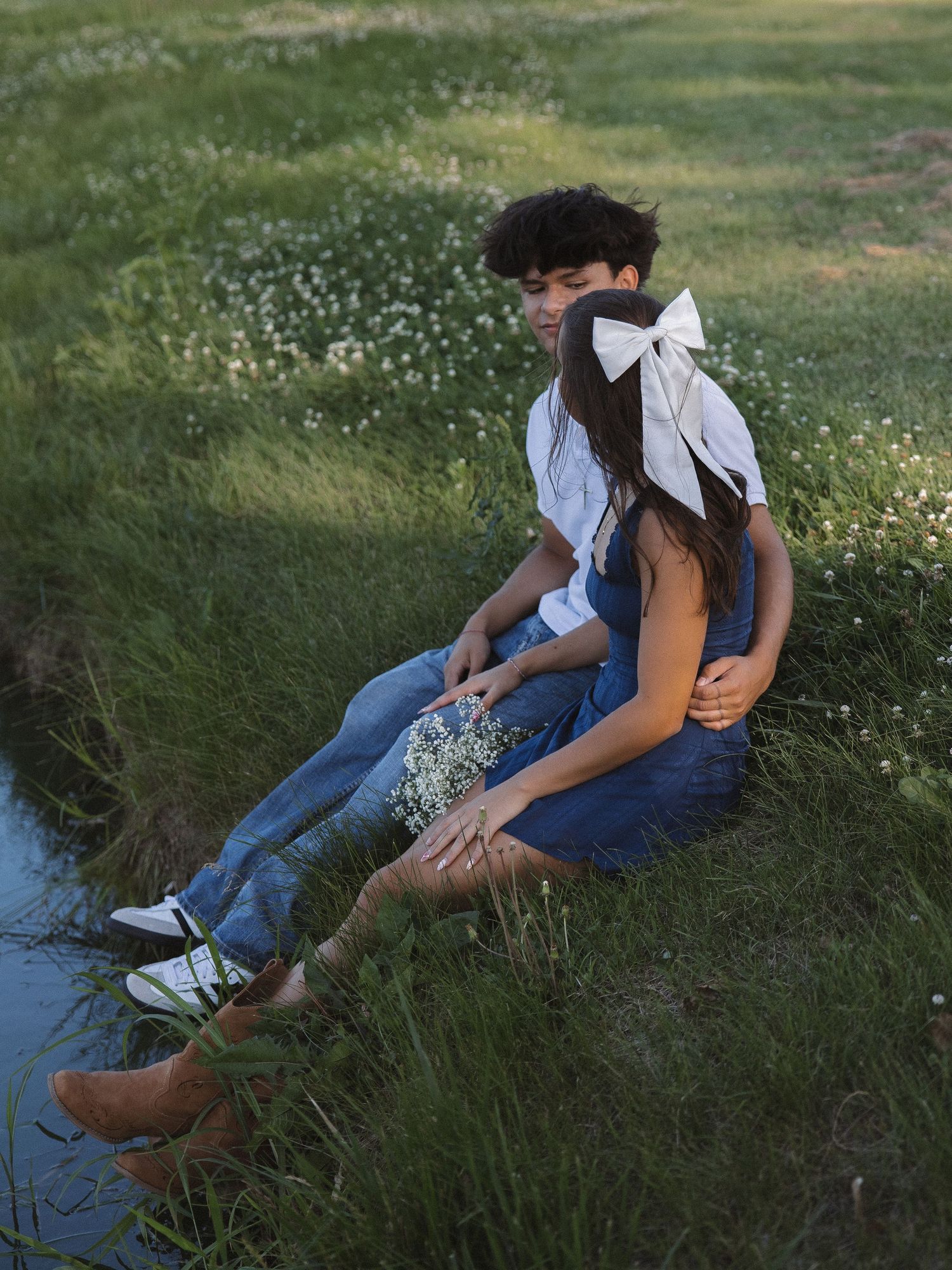 Couple portrait by water at sunset