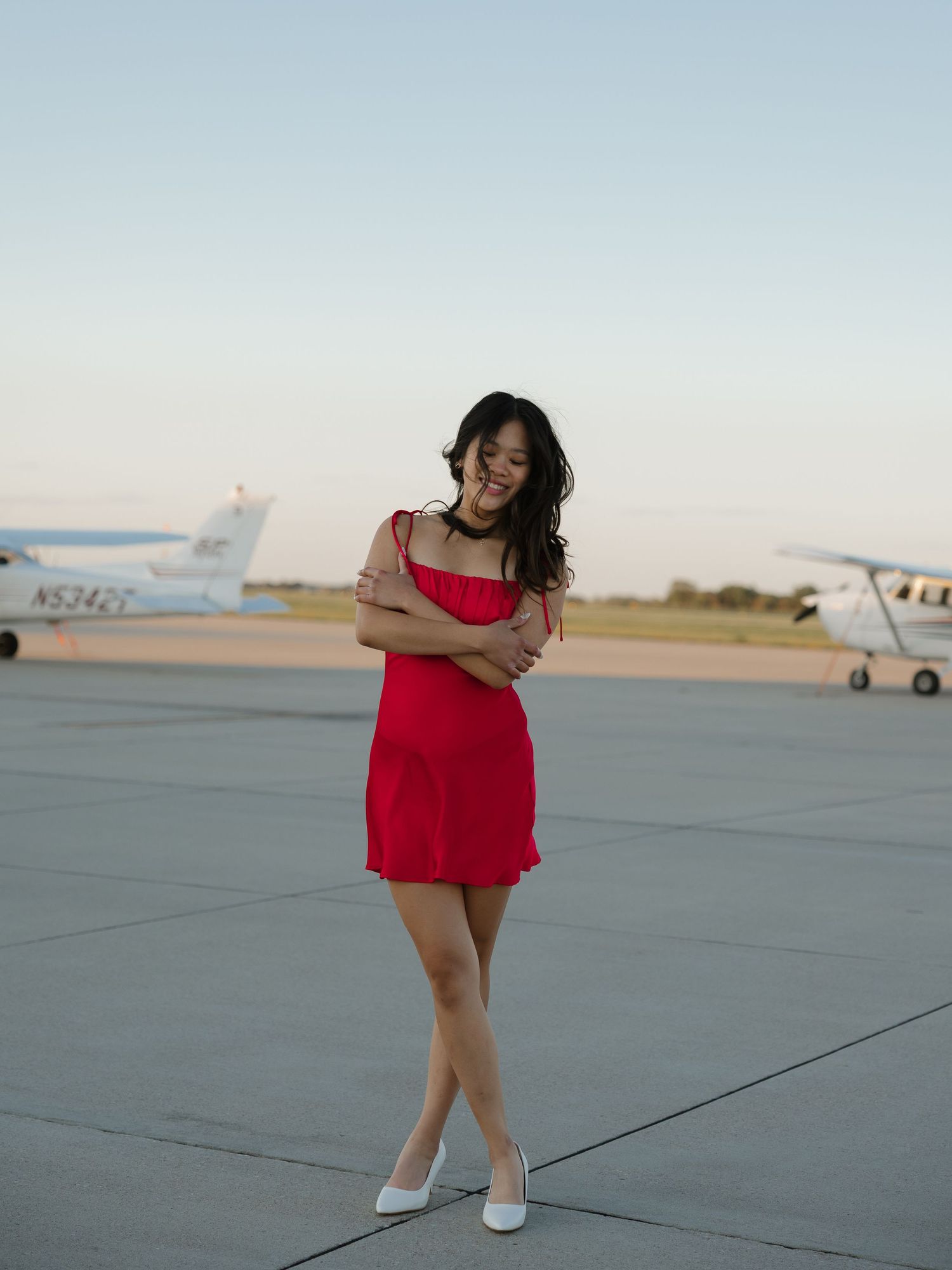 Graduate standing in natural light outdoors
