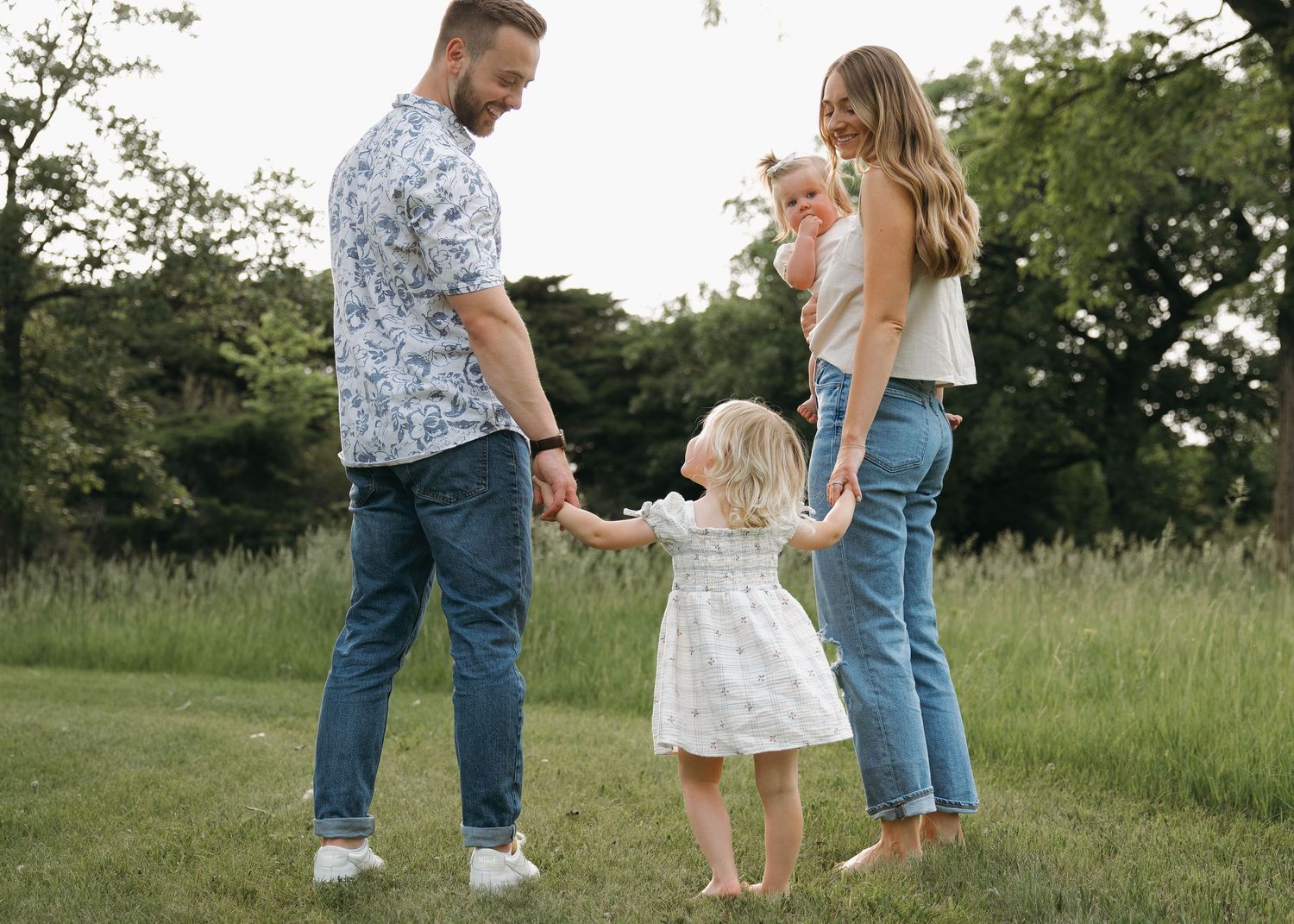 candid emotional family holding hands outdoors