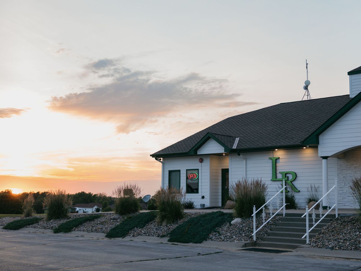 landscape of golf course club house and restaurant real estate photo at sunset