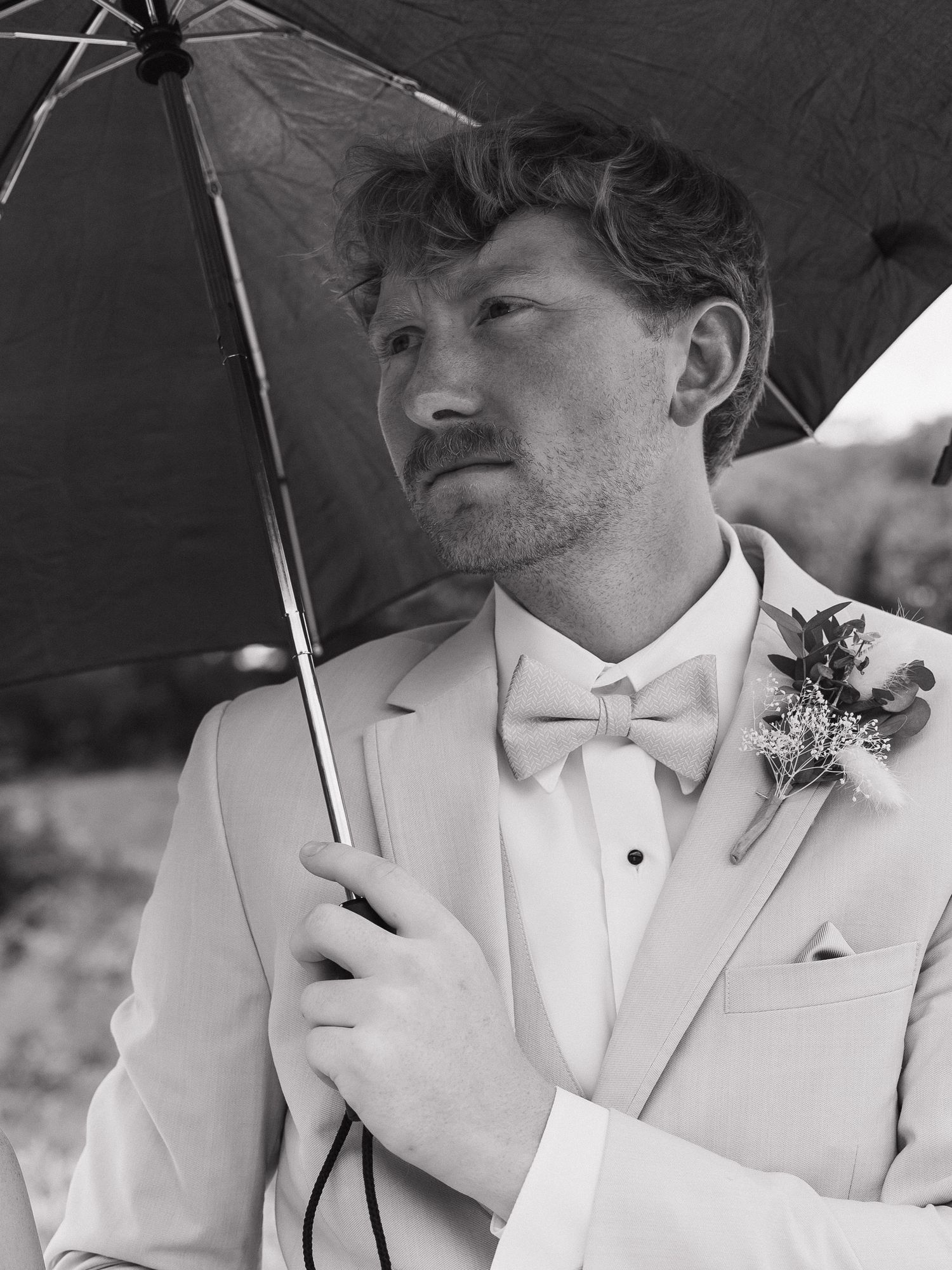 dramatic black and white groom portrait