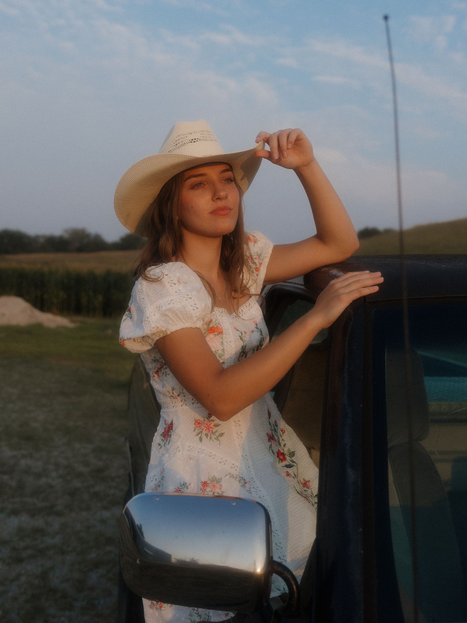 senior softly smiling towards sunlight golden hour