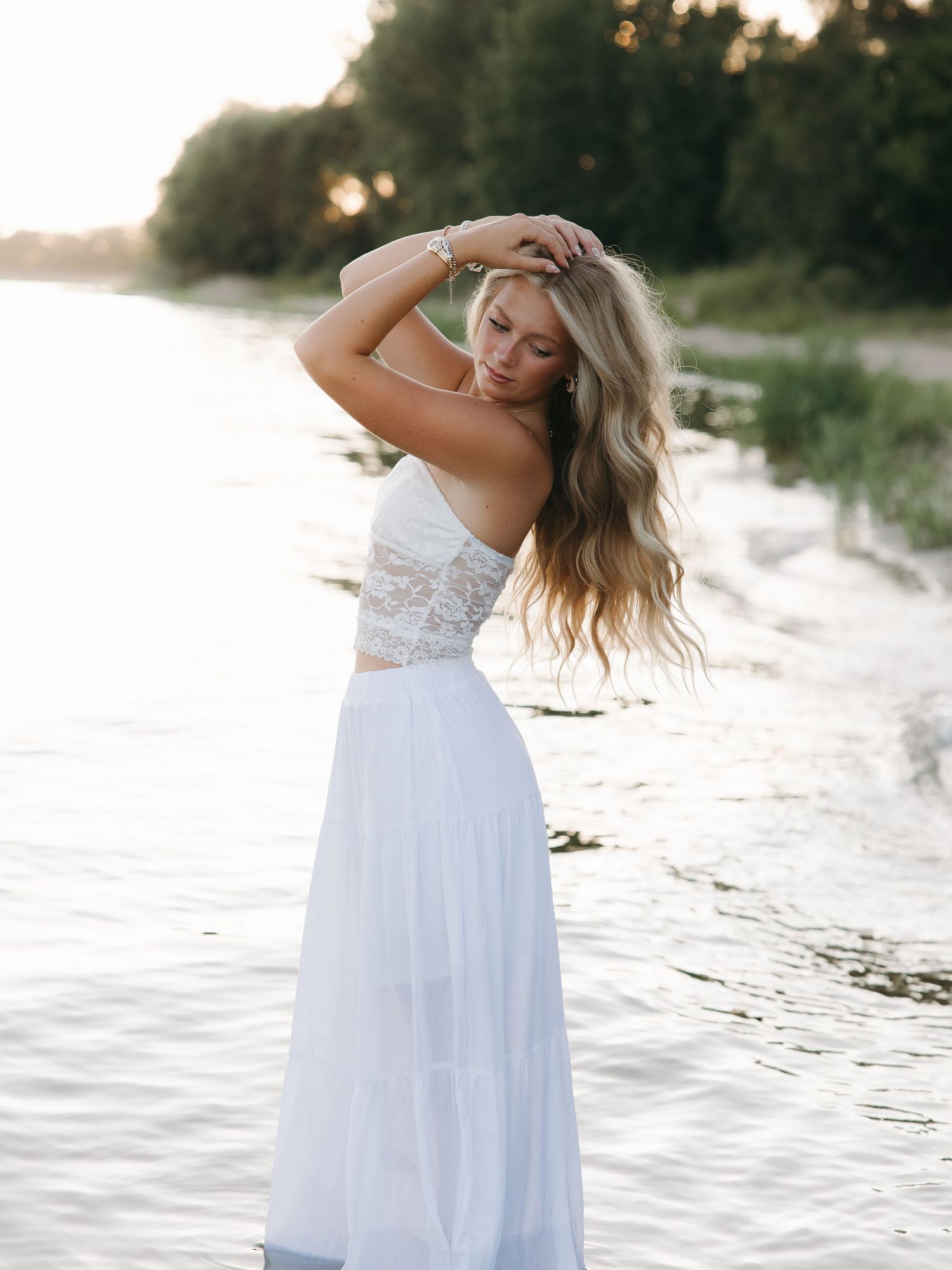 Outdoor graduation portrait with lake background