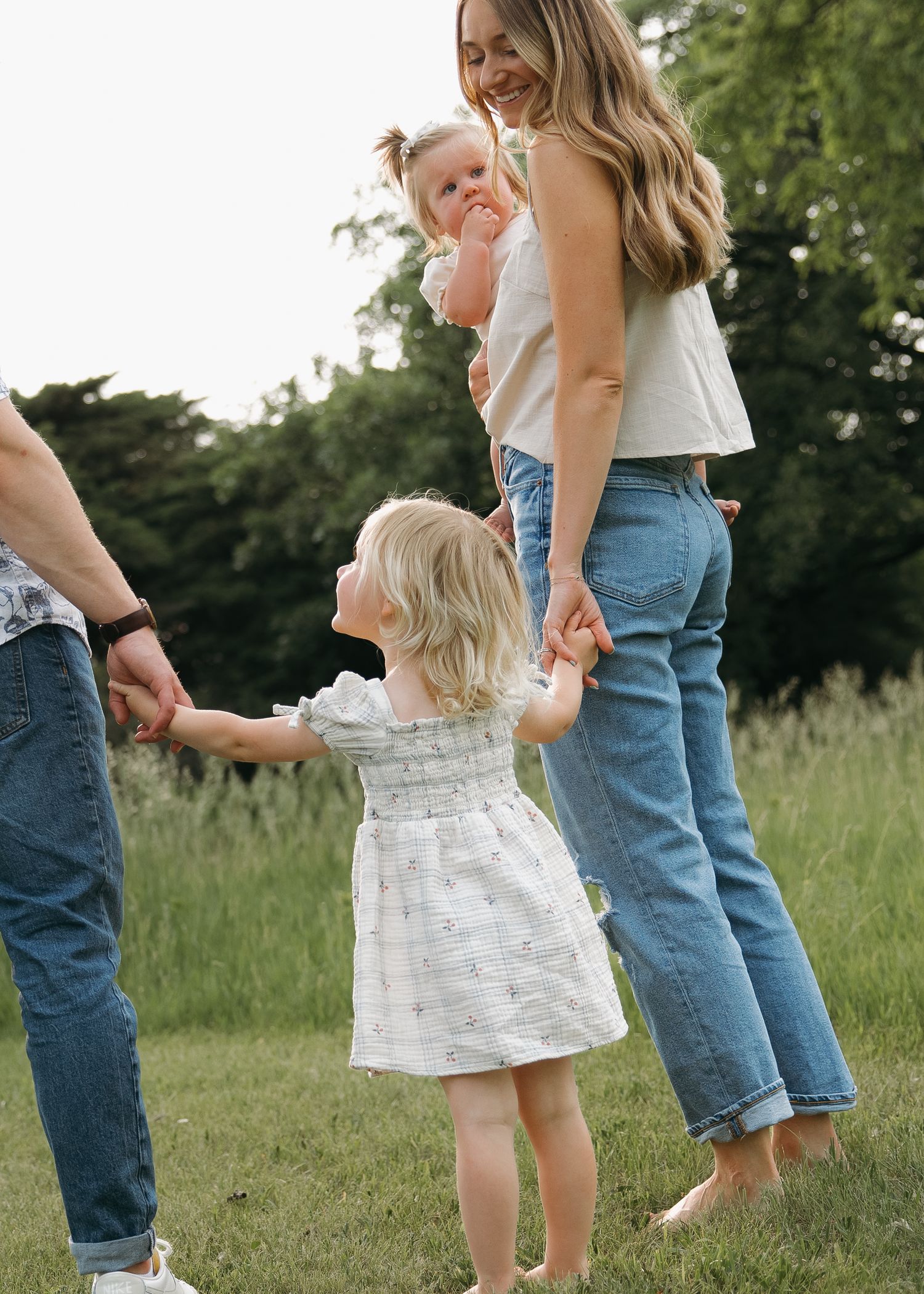 candid dramatic and classic family holding hands outdoors