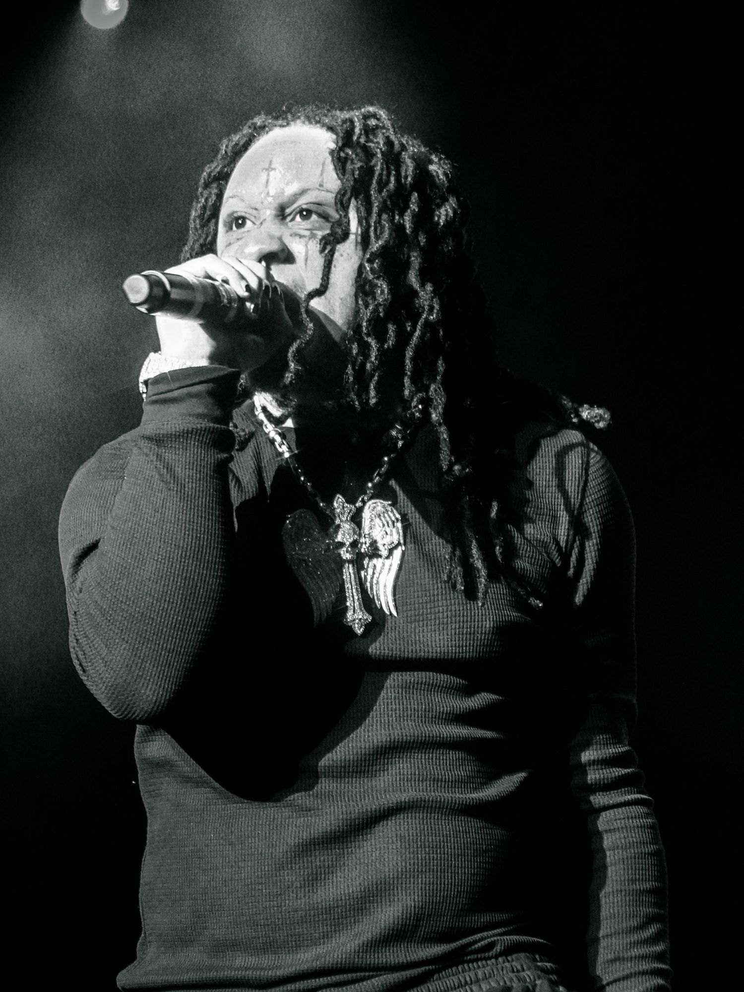 Black and white concert photos showing a performer on stage with dramatic lighting.