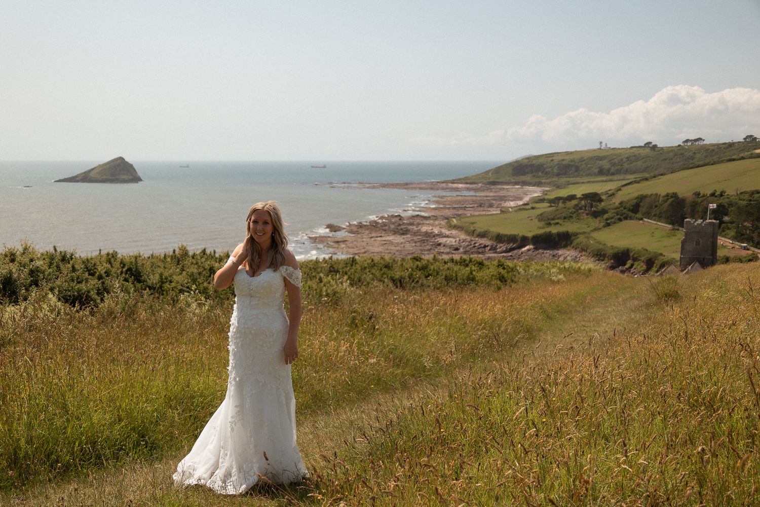Wide bridal portrait on top of the hill overlooking Wembury beach in South Devon