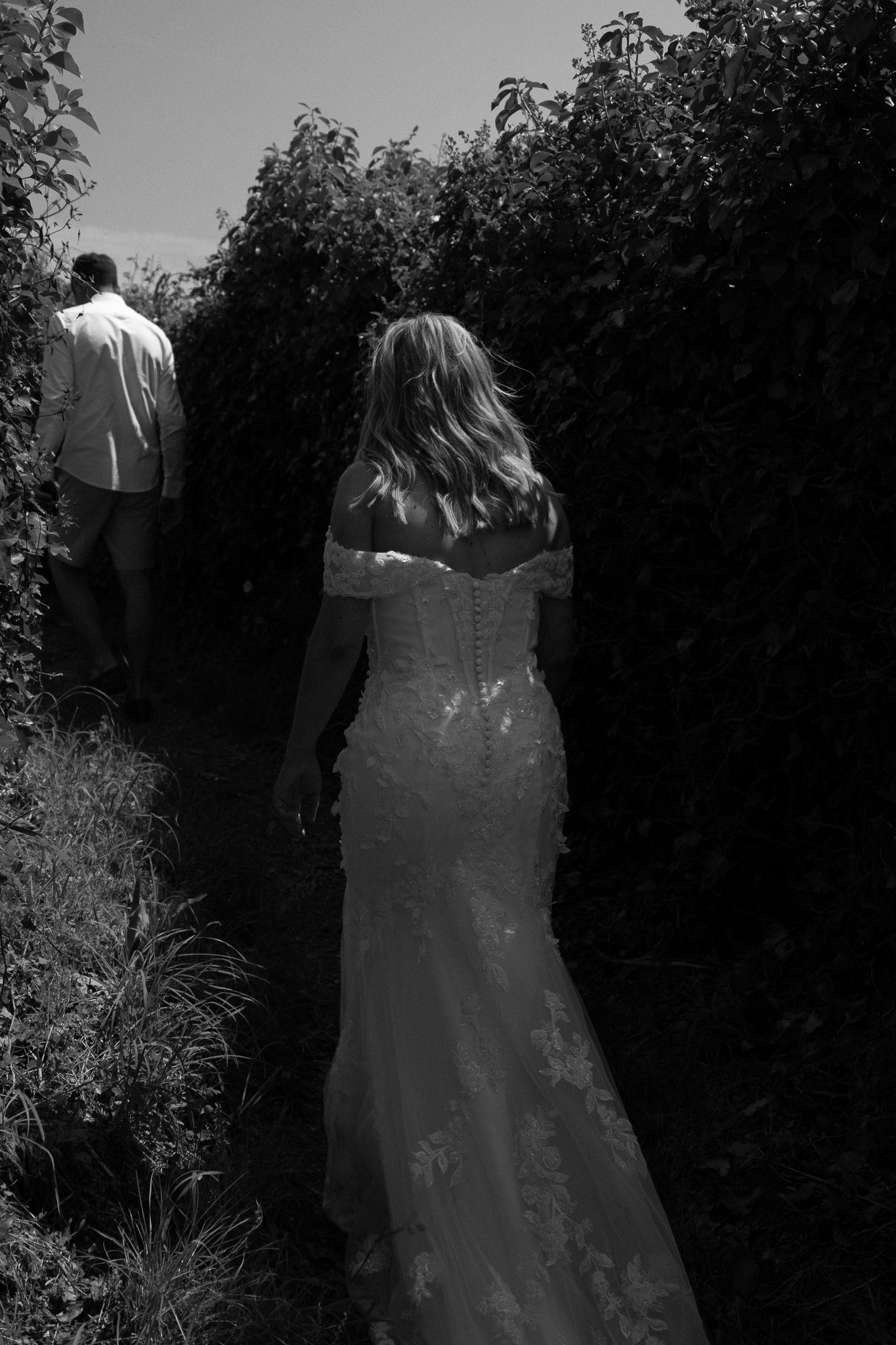 Bride following groom along the South West Coastal Path during couples portraits