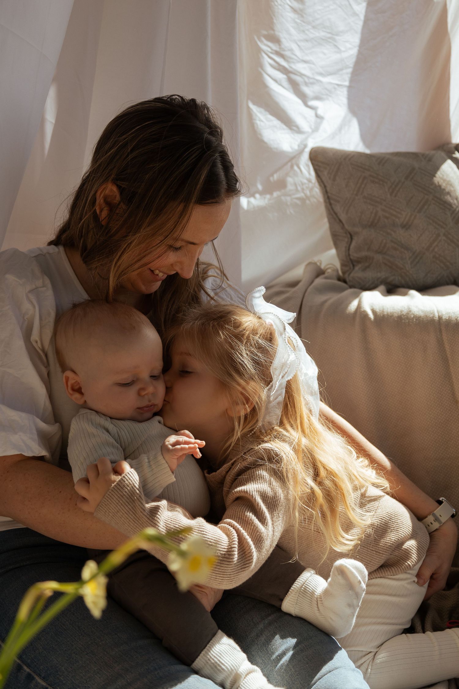 Mum and her children cuddled up during a natural studio session in Kingsbridge