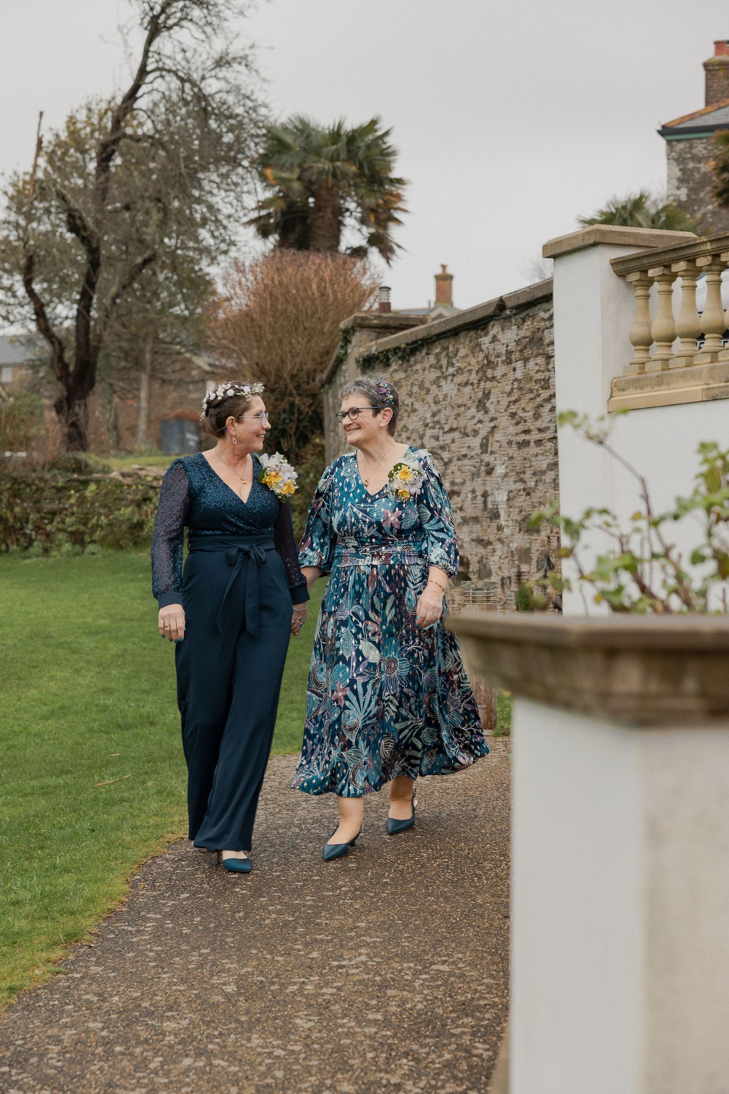 Same Sex Couple, Bride & Bride holding hands in the gardens at Thurlestone Hotel, Devon